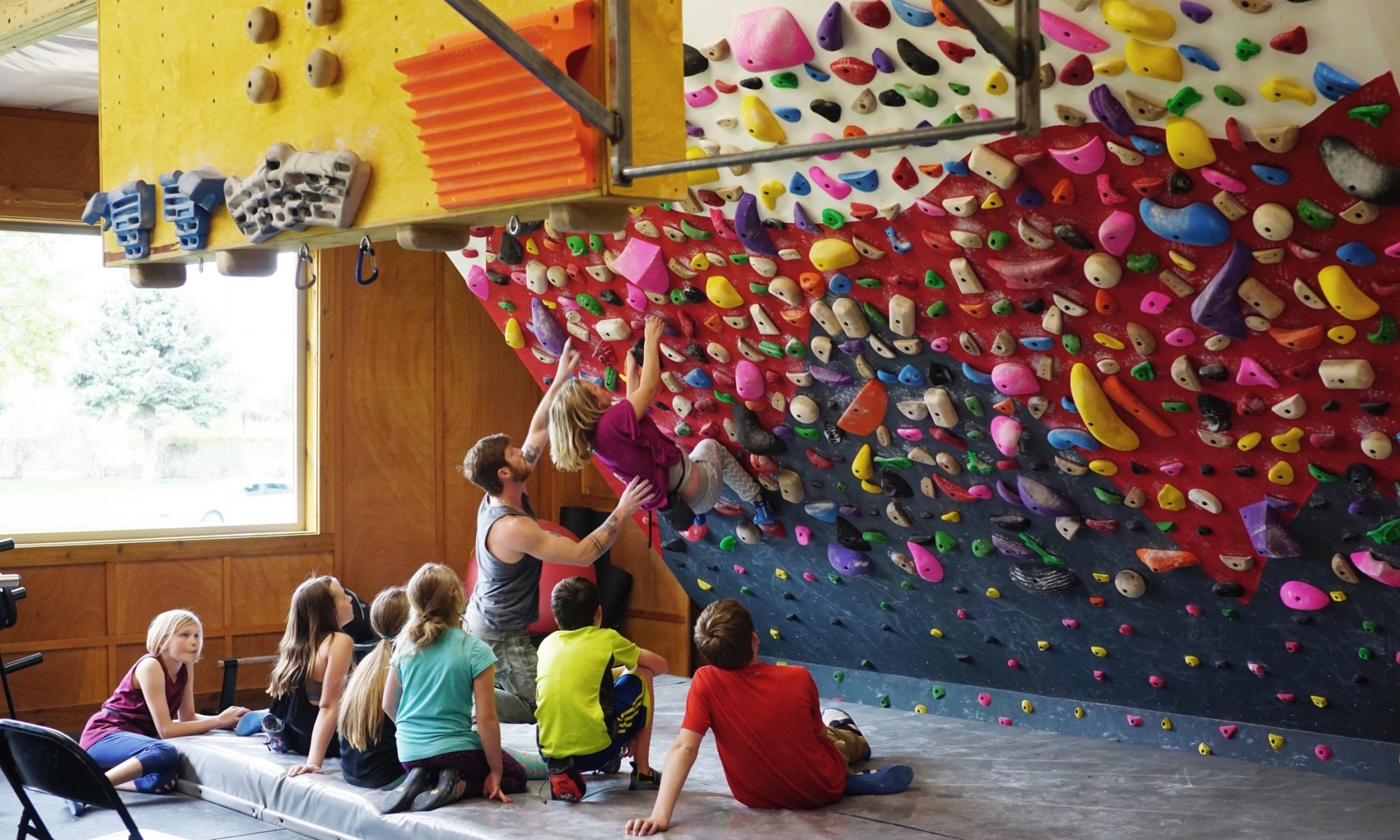 Head Coach Drew Schick teaching the kids technique on the training wall.