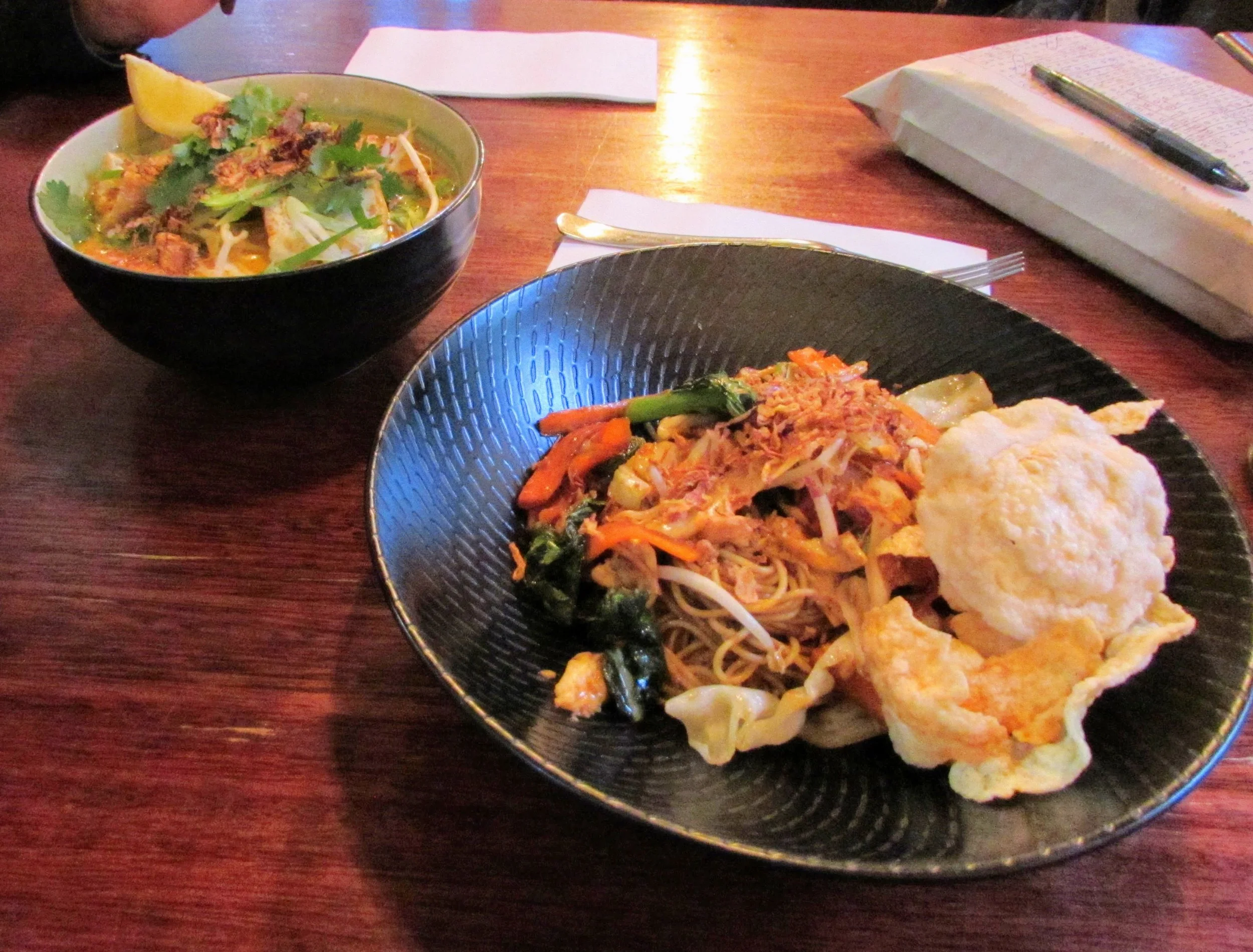 {Sorry for the dim photo}. The plate closest is my entree from Yuni’s, the Mie Goreng (stir-fried thin egg noodles with asian vegetables & fried egg). On the upper left is Emmett's Laksa (curry soup with noodles, cabbage, bean sprout, &tofu).