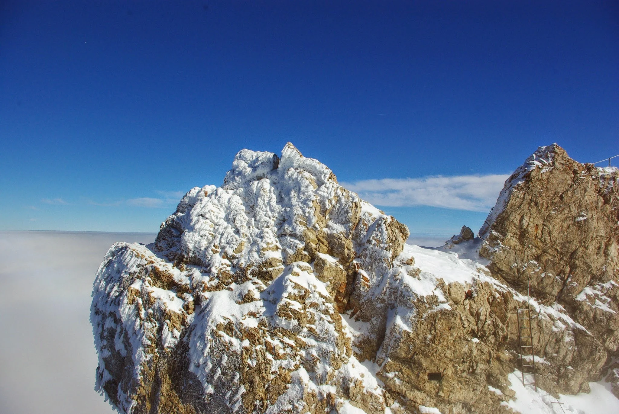 Our cable car rose out of the snow cloud and we got our first view of the snowy limestone summit.
