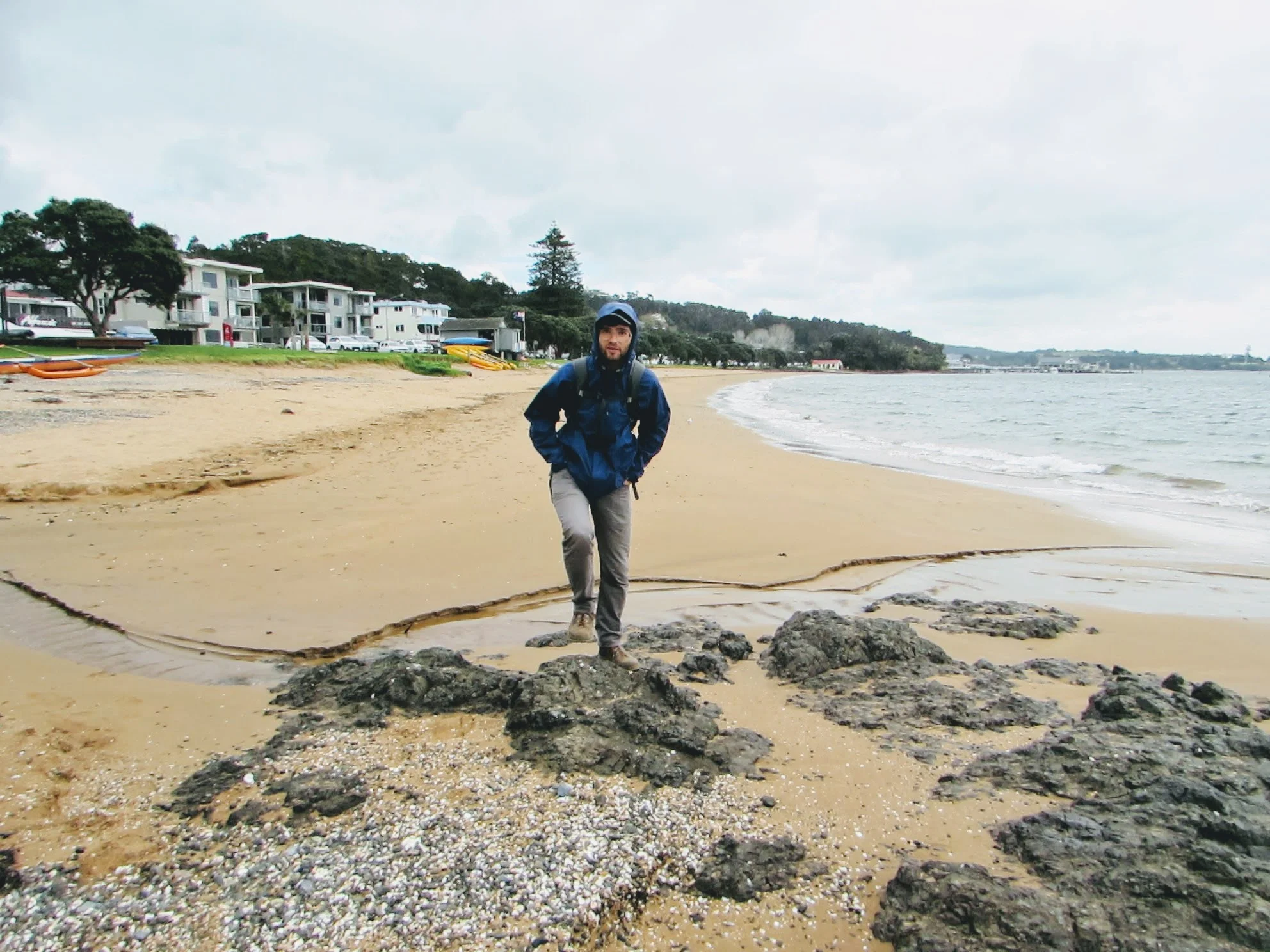 Emmett on a typical New Zealand rainy day on Paihia's beach.