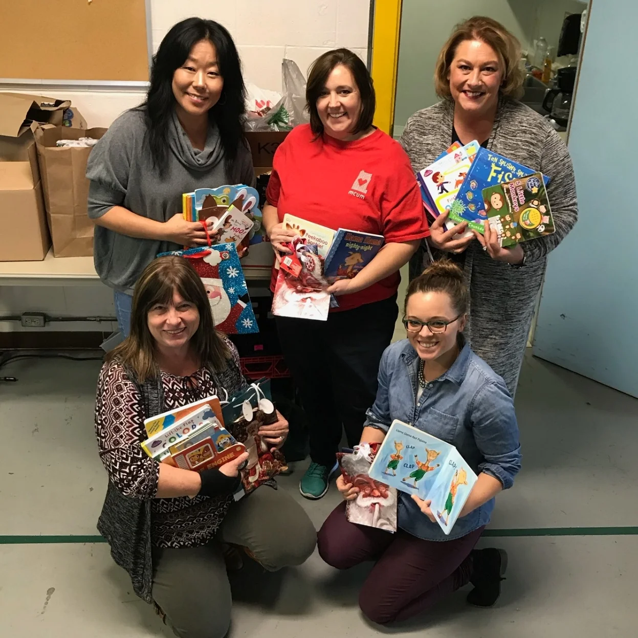 Members presented over 150 books, as well as gift bags and tissue paper, to the Monroe County United Minitries’ (MCUM) daycare program. The donation will helped provide Christmas gifts to about 140 area children. Front, from left, are Tri Kappa Beth Murray and MCUM’s Katie Broadfoot; in back, Tri Kappa Community Service Chair Maria Douglas, left, and President Amanda Burnham stand on either side of Shannon Hampton, MCUM’s office manager. (Featured in the Herald Times, December 2017)
