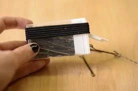 This one you don't have to keep to just travel! You will find this in my purse on any given day. Empty out a tic tac case and place your bobby pins in the container. 