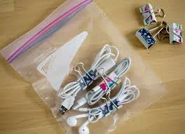 This simple DIY hack is incredibly efficient - and cheap! Take your cords and wrap them with a binder clip, then place them all in a sandwich or gallon size zip lock depending on your needs. 