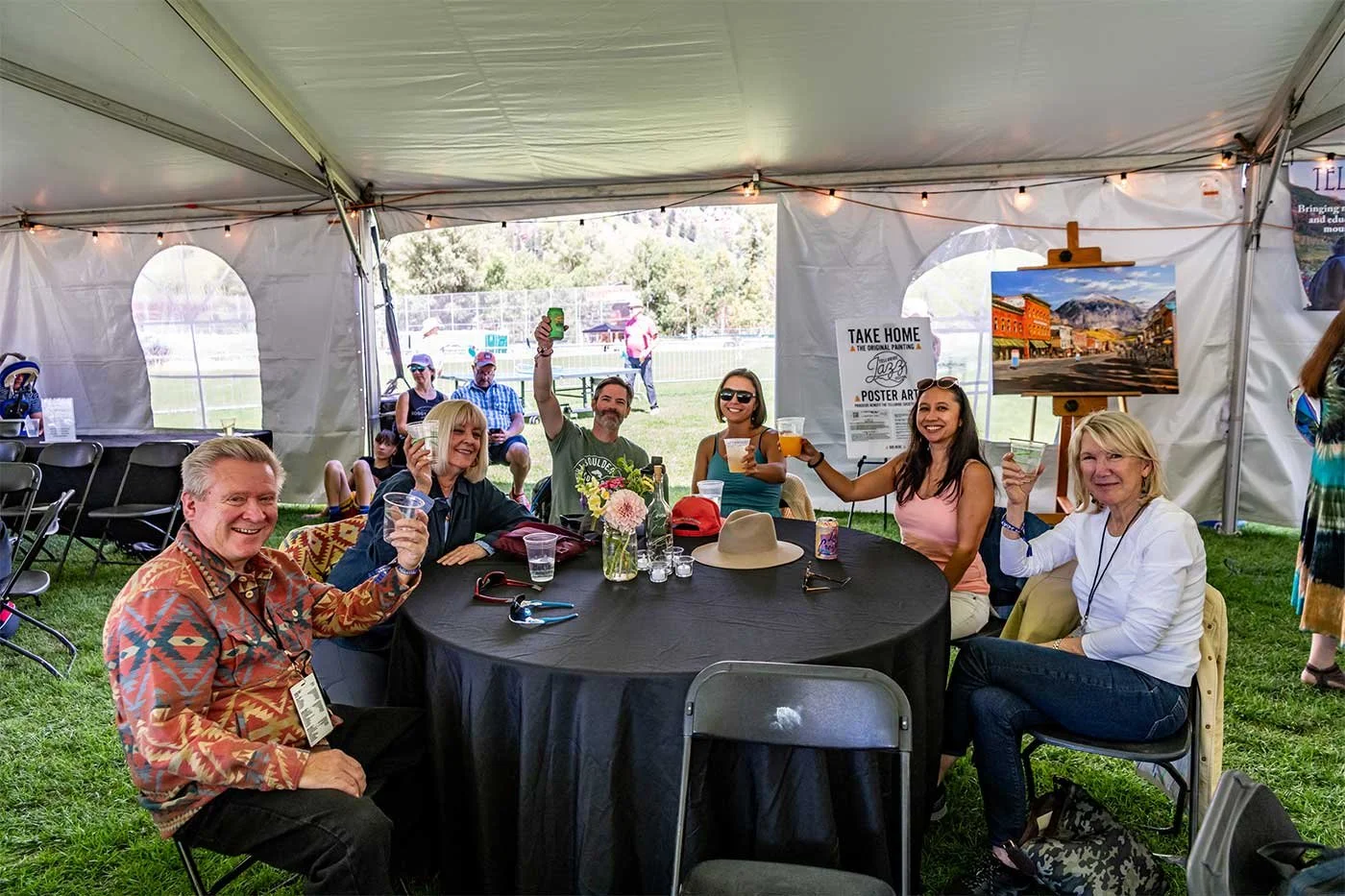 Friends enjoying drinks together inside the Telluride Jazz Festival VIP Lounge, celebrating with cocktails and sharing a memorable festival experience.