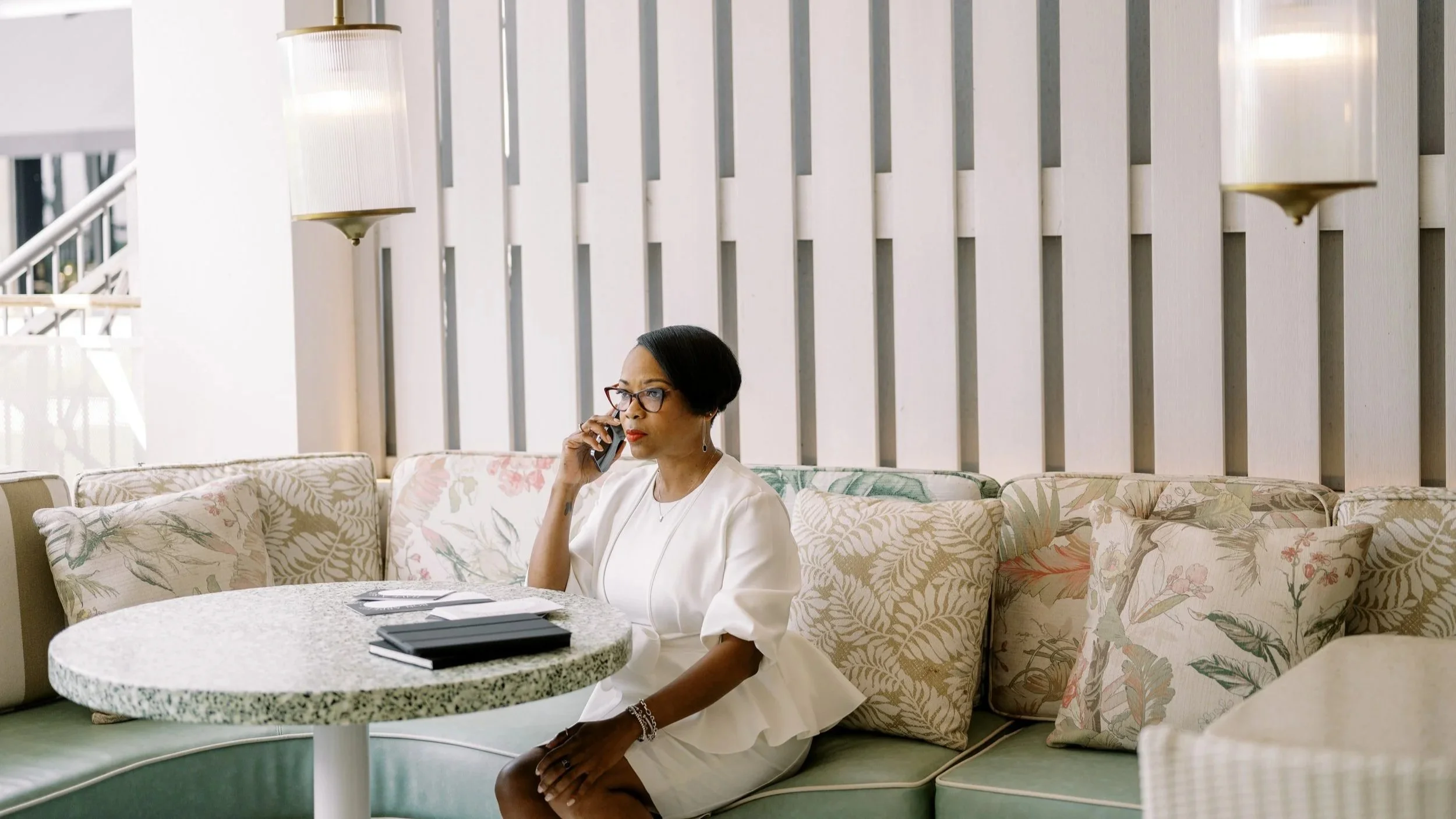 Desiree Dent, the Founder of Dejanae Events, is on the phone talking to a client.