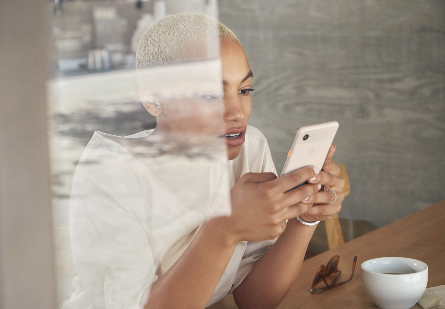 Black woman bleached blond on phone tech.png