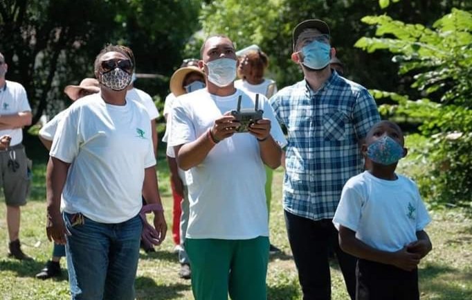 youth learning to fly drone on site.jpg