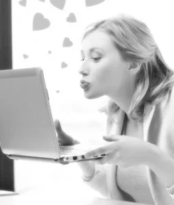 woman kissing computer