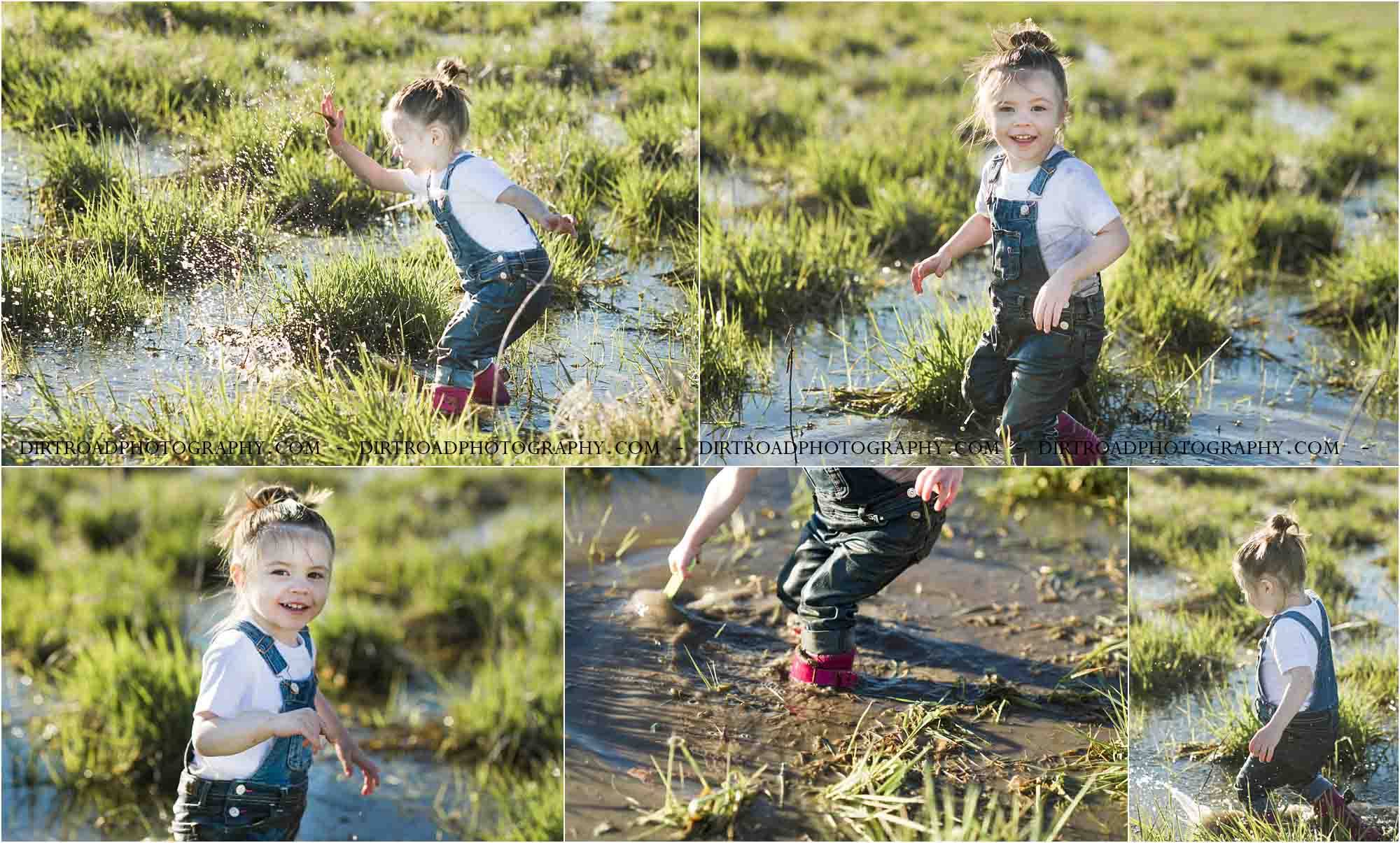 Muddy Mini Sessions held near Wilber, Nebraska with Photographer Kelsey Homolka Nerud from Dirt Road Photography. Picture of three year old girl splashing water into the air at sunset wearing jean overalls, pink mud boots and a white t-shirt. Toddler girl in photos of Nebraska Child Photographer.