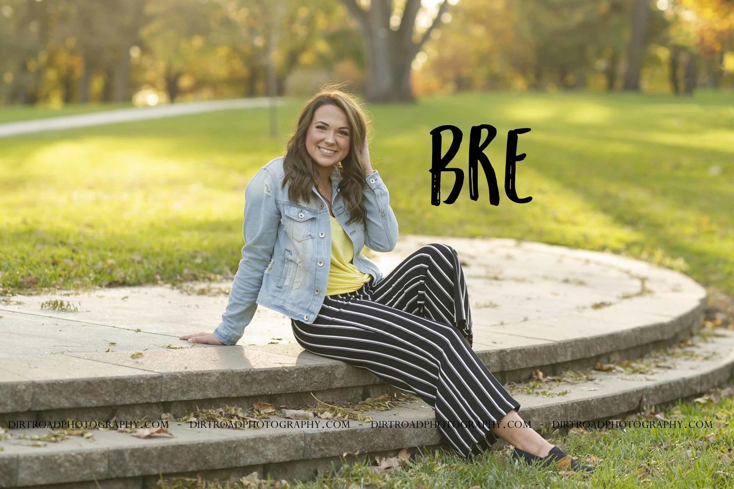 images of high school girl senior photos named bre zoubek of wilber nebraska who went to wilber-clatonia high school in nebraska and is part of the class of 2019. photos were taken near crete nebraska in saline county at doane university formerly doane college of crete. photo includes tall glass buildings, brick and cement bridges, fall leaves, sunsets, pond with swans, and dirt roads. girl is dressed in striped black and white pants, steven madden shoes, yellow tank top with denim jacket with long brown hair and styled make-up. dirt road surrounded by trees and dust at sunset. tall grass with a sunset behind as well. photographer is kelsey homolka nerud of wilber nebraska who specializes in high school senior photography and senior pictures.