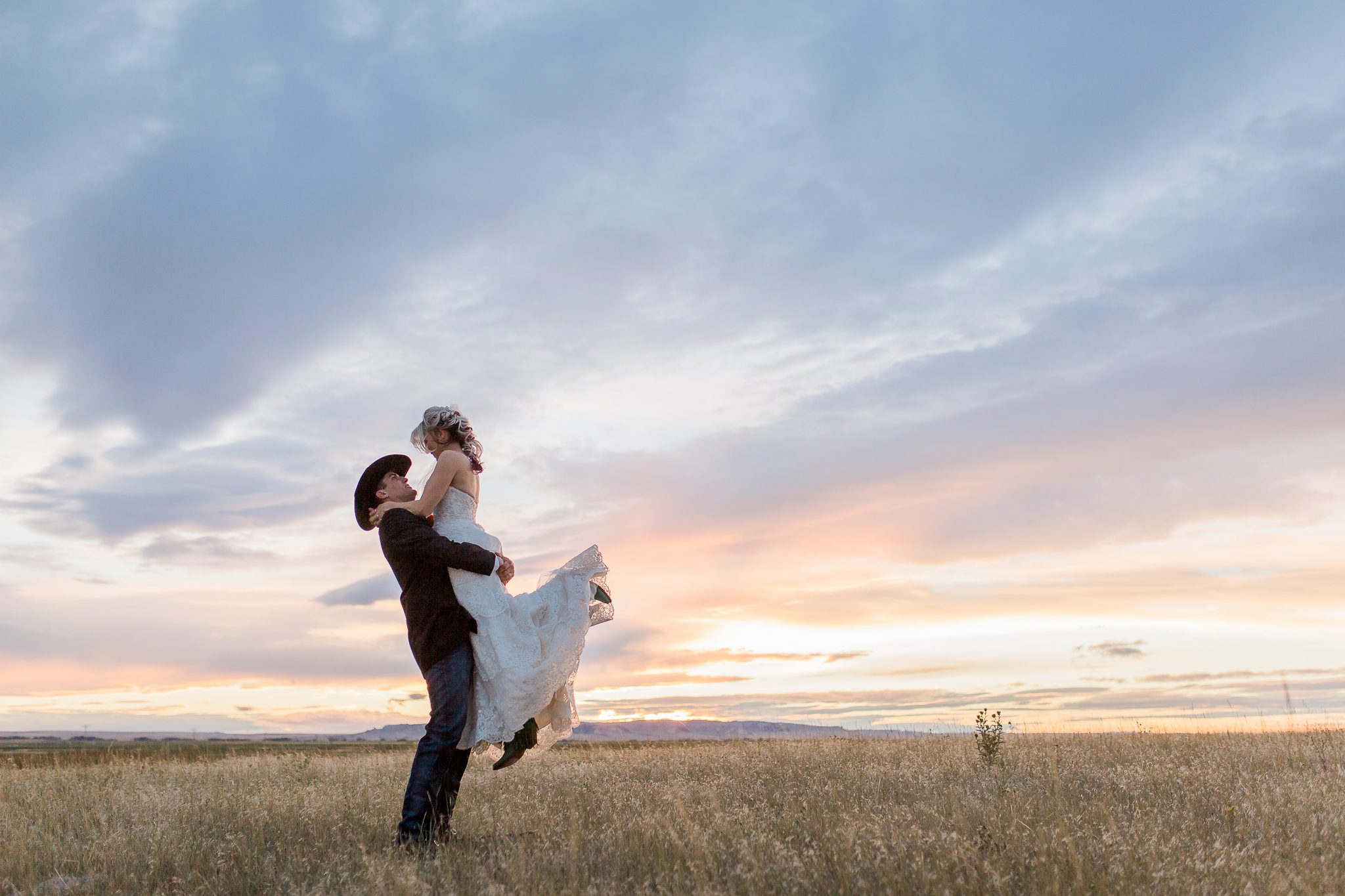 The most spectacular sunset was the perfect end to Charla and Dalton's wedding day in Lagrage, Wyoming last summer. Their entire wedding day was the picture of western romance see more here: https://www.wyomingweddingphotographer.com/megan-lee-photography/charla-dalton-wyoming-ranch-wedding