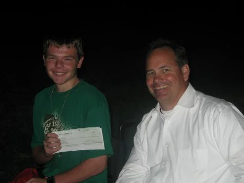 Joey receiving a check from Eric and Head North