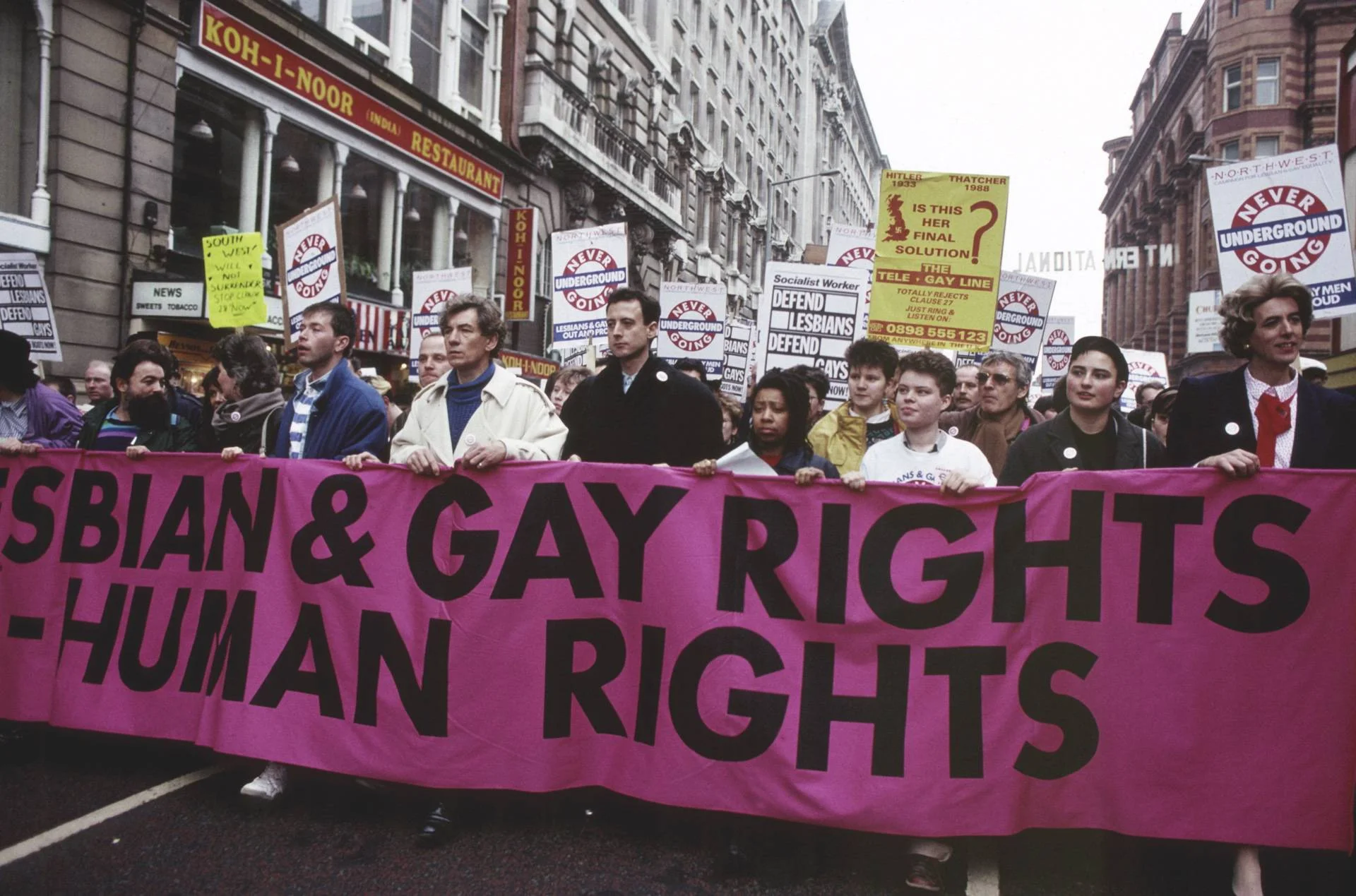 Sir Ian McKellen, Peter Tatchell & Louise Wellwein (pictured third from the right in the white) in Manchester on March Against Section 28, February 1988. Photography: Alamy Stock Photo