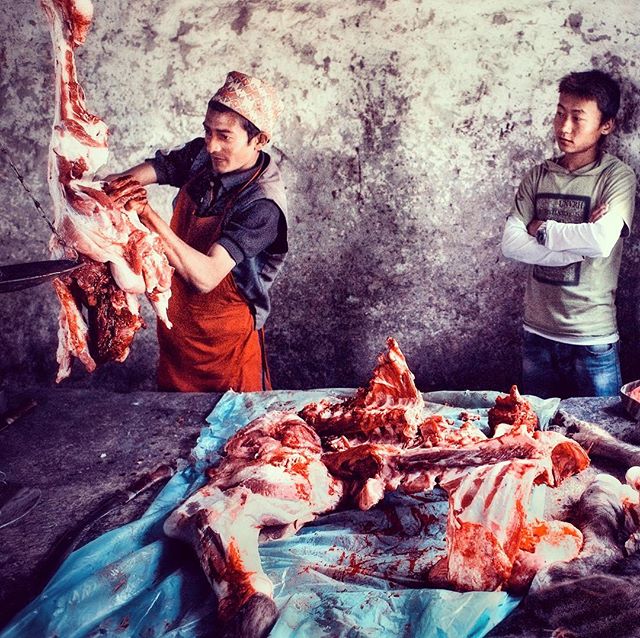 Butcher working at market day in Necha, Solu. The one day in the week that villagers will have meat from buffalo, goat and pork. #food #meat #solu #nepal #butcher #veg #market #flavoursofnepal