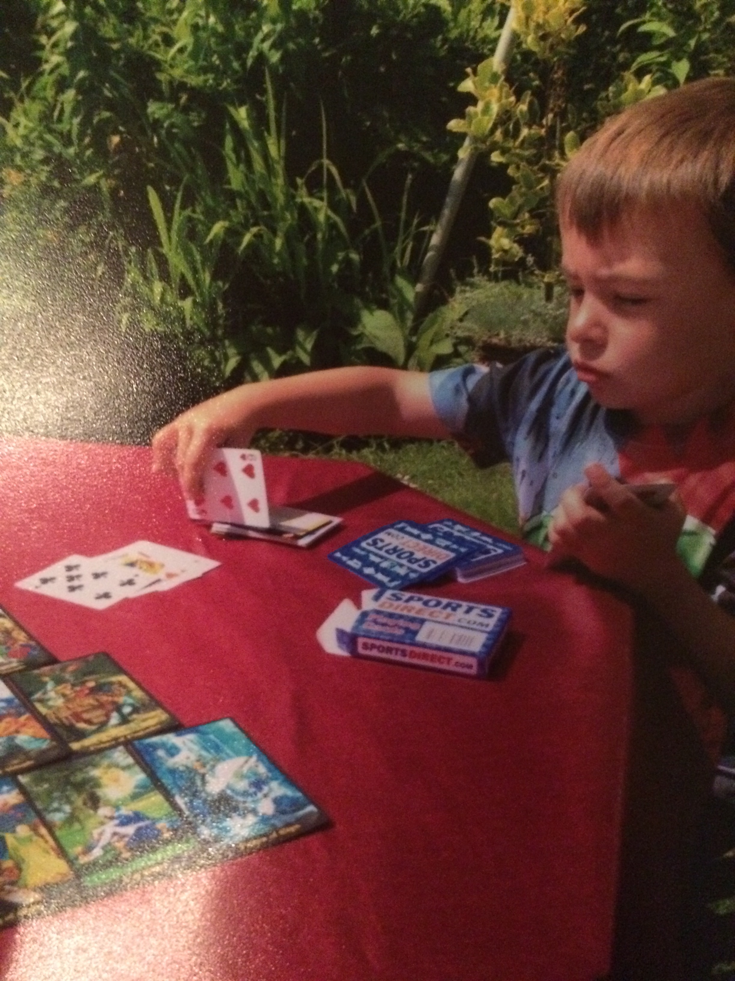 This is a picture of my nephew learning fortune telling as a child a couple of years back. In Gypsy culture, men generally don't practice divination or tarot but he was curious so I started teaching him some beginners techniques.