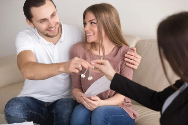 young-smiling-couple-owners-getting-keys-own-house-apartment_1163-4180.jpg