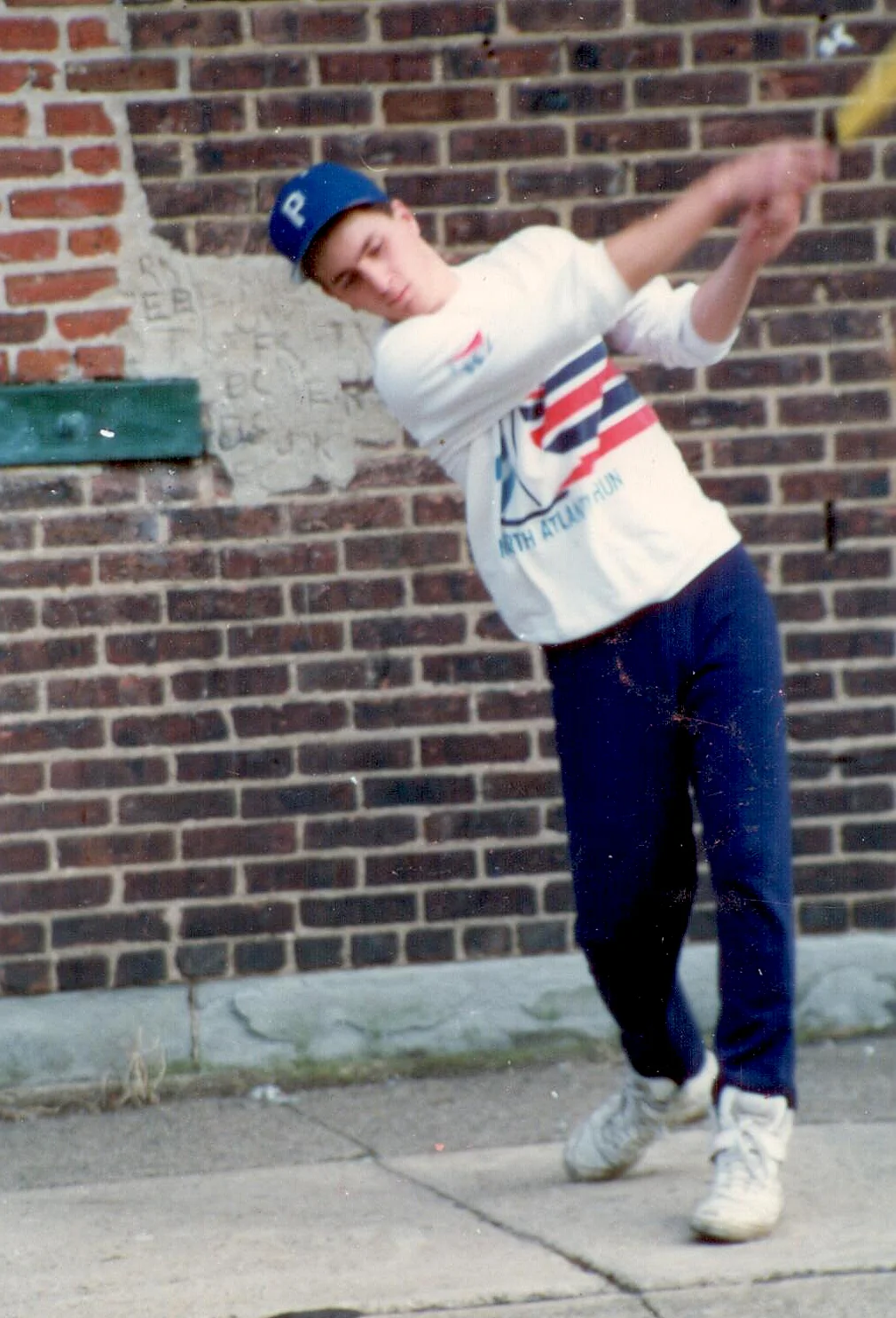 A young Wiffleczar takes a hack across the street from his childhood home. The brick wall in the background served as a de facto strike zone and backstop.