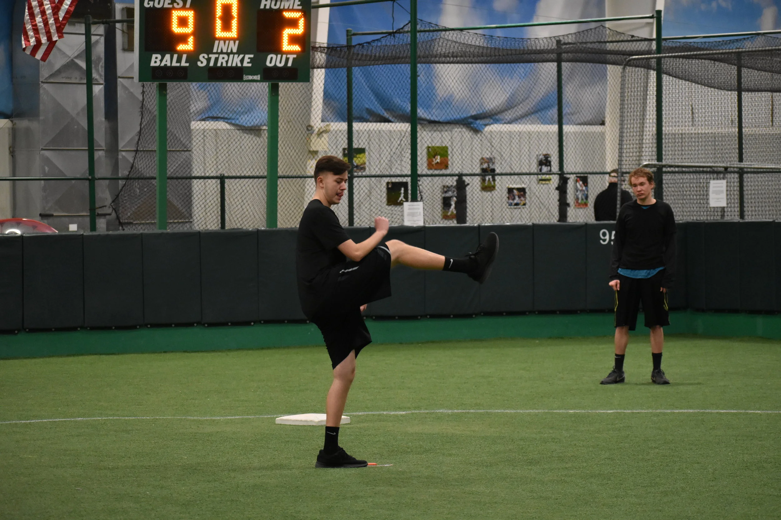 Young southpaw Blake Hoffman (ERL) gets ready to deliver a pitch as teammate Joe Schlindwein looks on from the outfield.