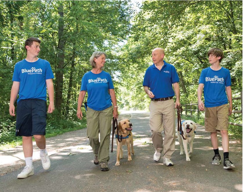 Connor, Caroline, Jody and Evan take a stroll on the Rail Trail with BluePath Benni and pet dog, Kermit.