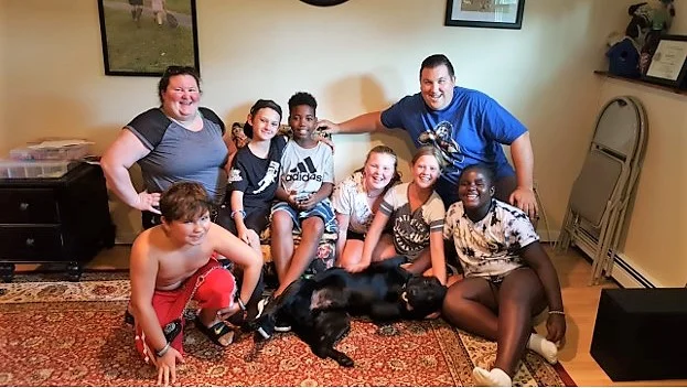 The Carlin family with Chester, who graduated as an autism service dog last week