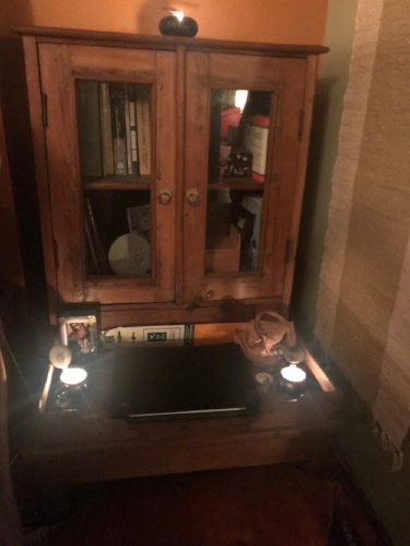 My Indian Teak alter that I found in the back corner of an antique shop fifteen years ago. It's hardware is brass lotus flowers and it's filled with many of my favorite things; books, memories of those who have passed, Runes & Tarot Cards.