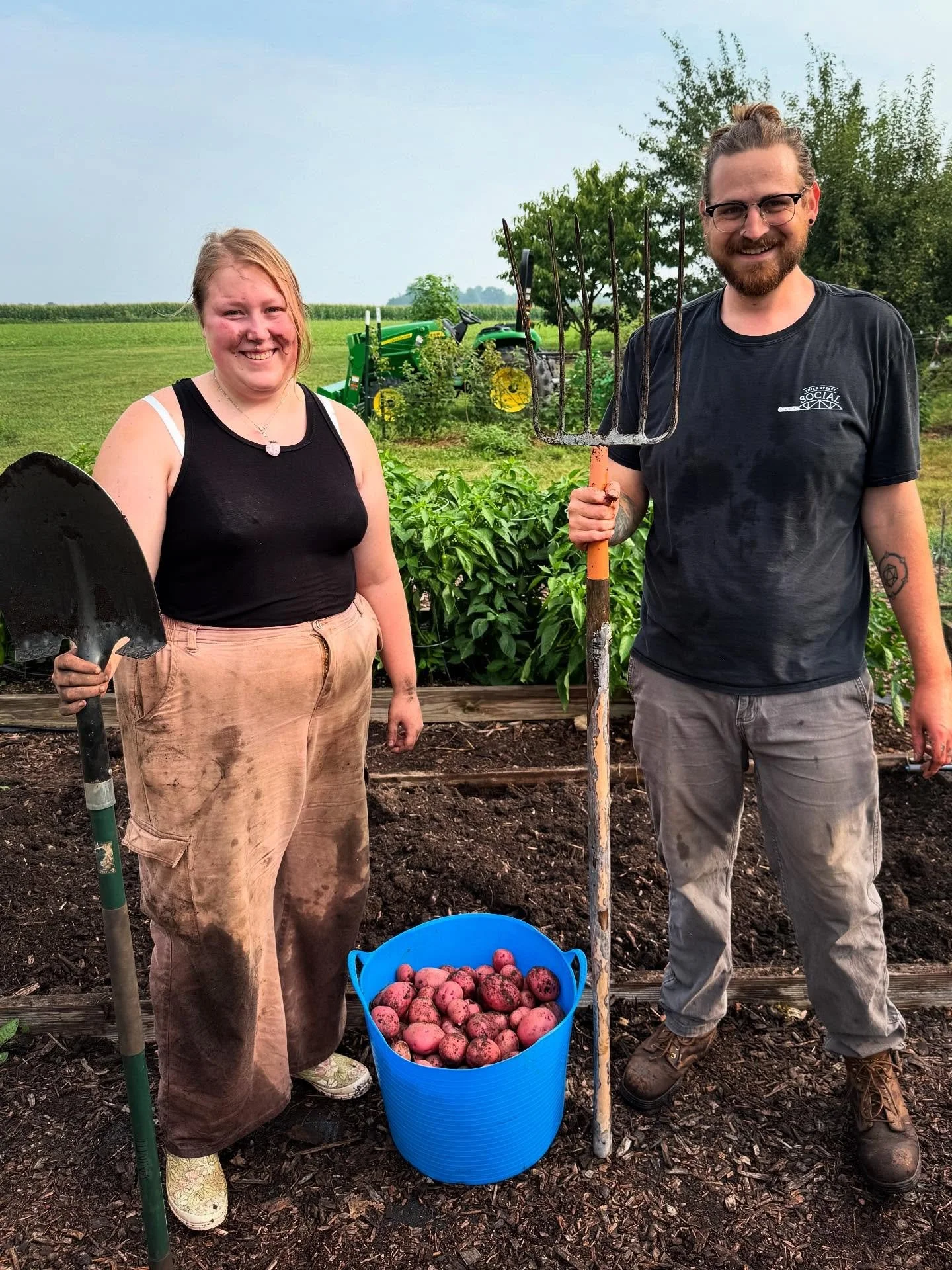 The idea was to do an homage to &quot;American Gothic,&quot; but our models were so giddy about this year's first potato harvest that they couldn't keep a straight face! Meet Maddie &amp; Scout, our seasonal Assistant Grower &amp; full-time Fruit &am