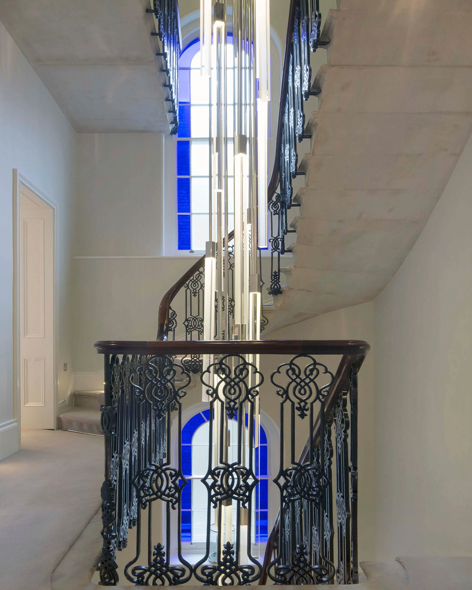 The refurbished main staircase surrounding a new modern light sculpture