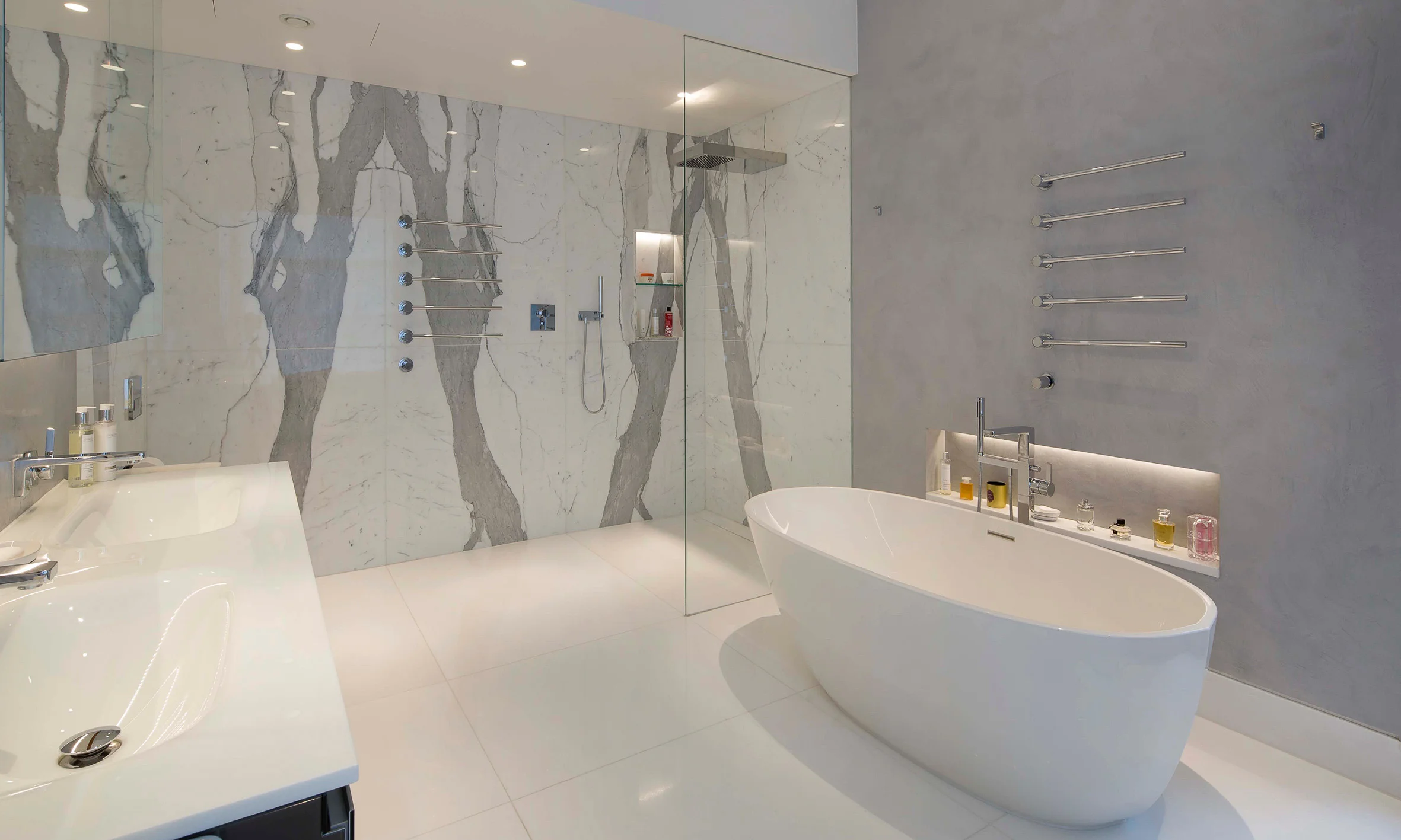 The master bedroom for Carlton Hill. Book matched marble and luxury brasswear.
