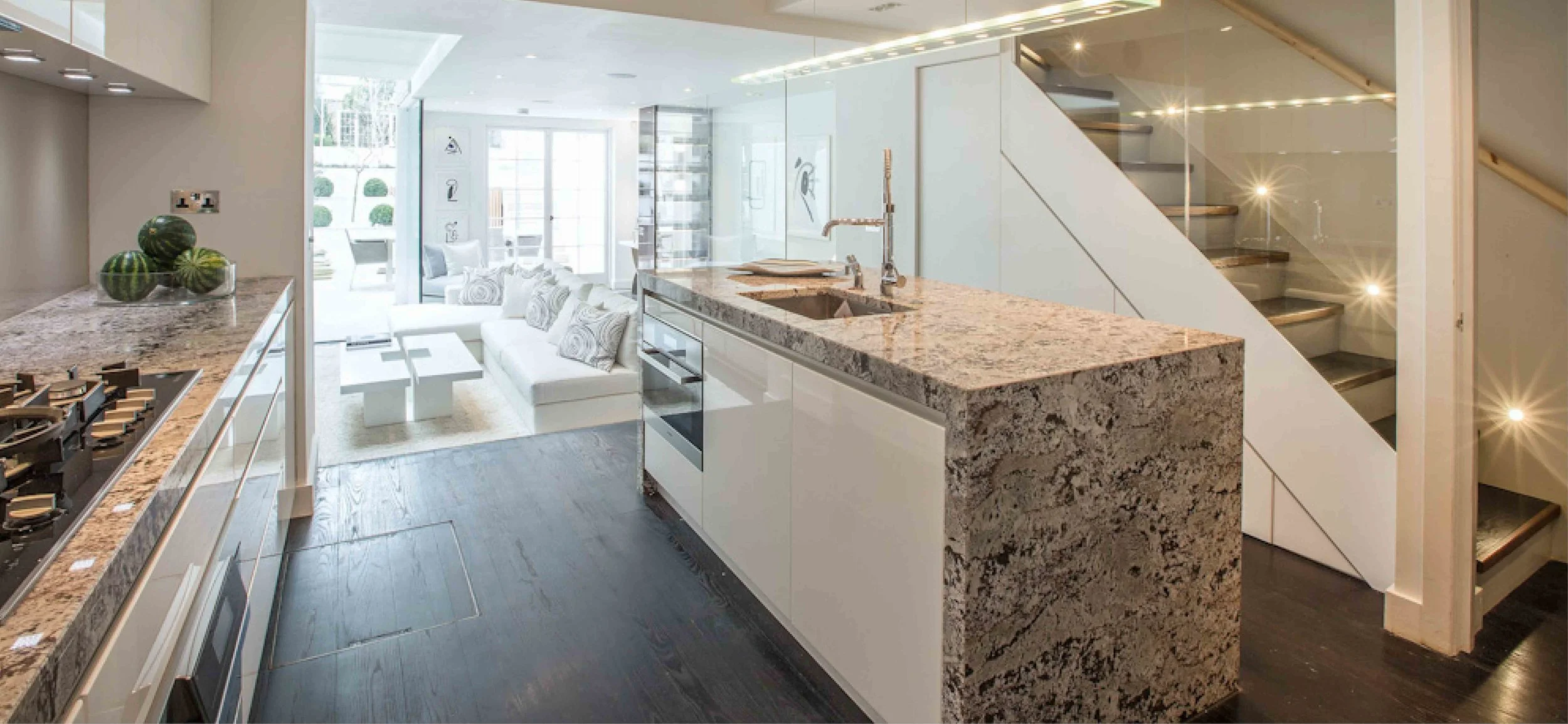 ___ marble worktops finish this modern kitchen. The island contains the oven and sink. The space leads into the new extension creating the main living space for the property,
