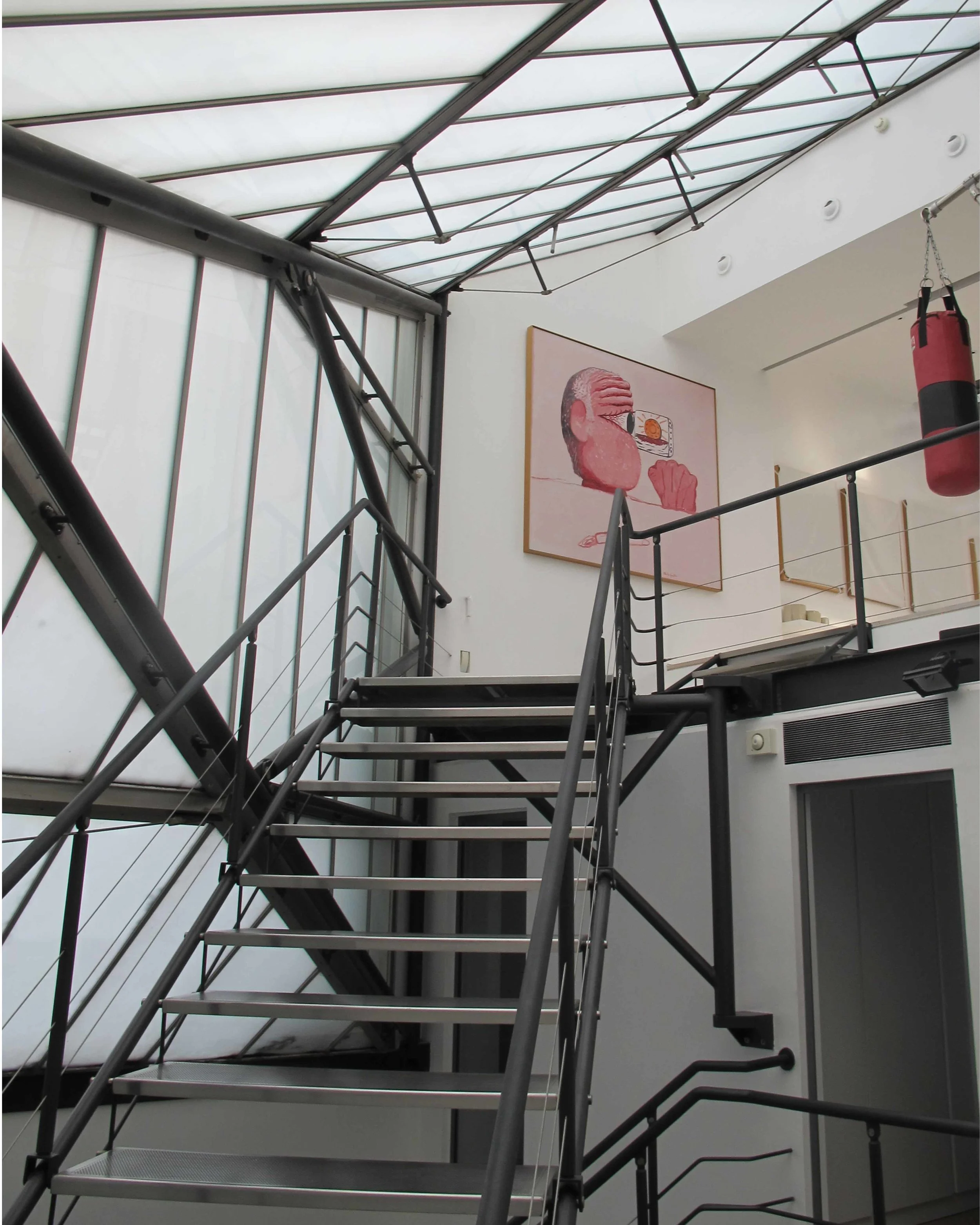 The modern glass and steel extension linking the lower floors of the property.