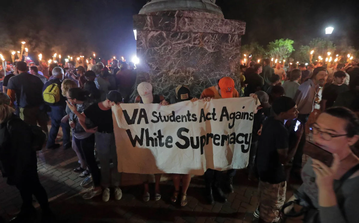 Tenacious UVa students circle the Thomas Jefferson statute on August 11, 2017. Photo courtesy of Daily Progress.