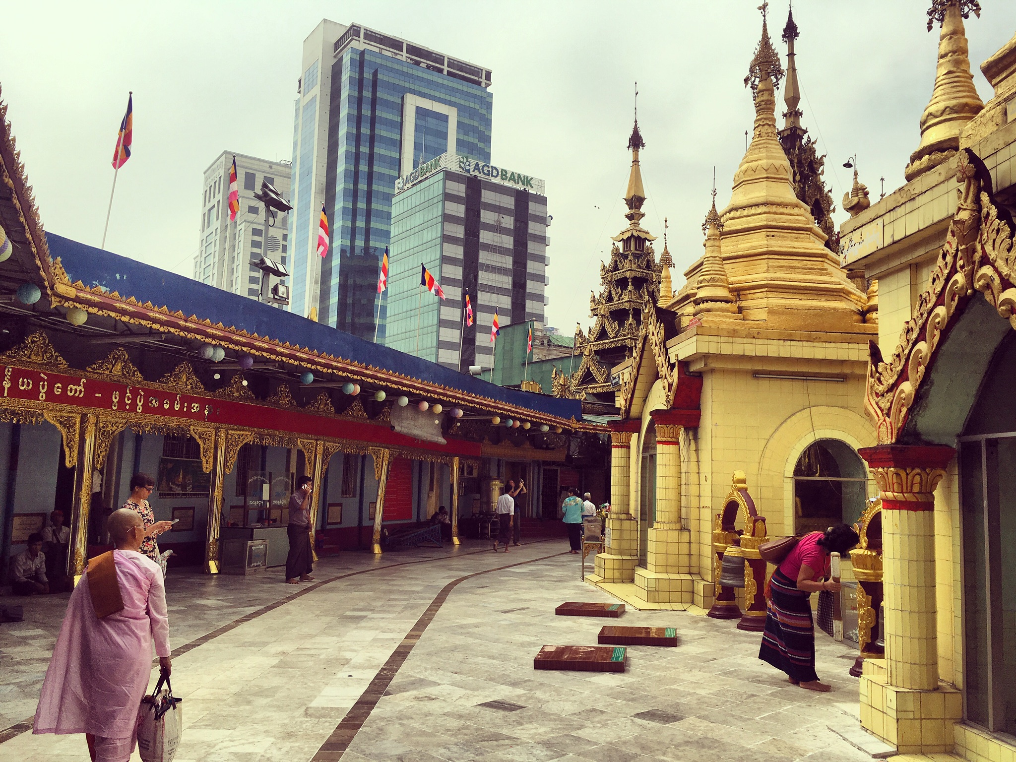 A monk walks by a Buddhist temple in Myanmar. Photo courtesy of Maria C. Dieuzeide.