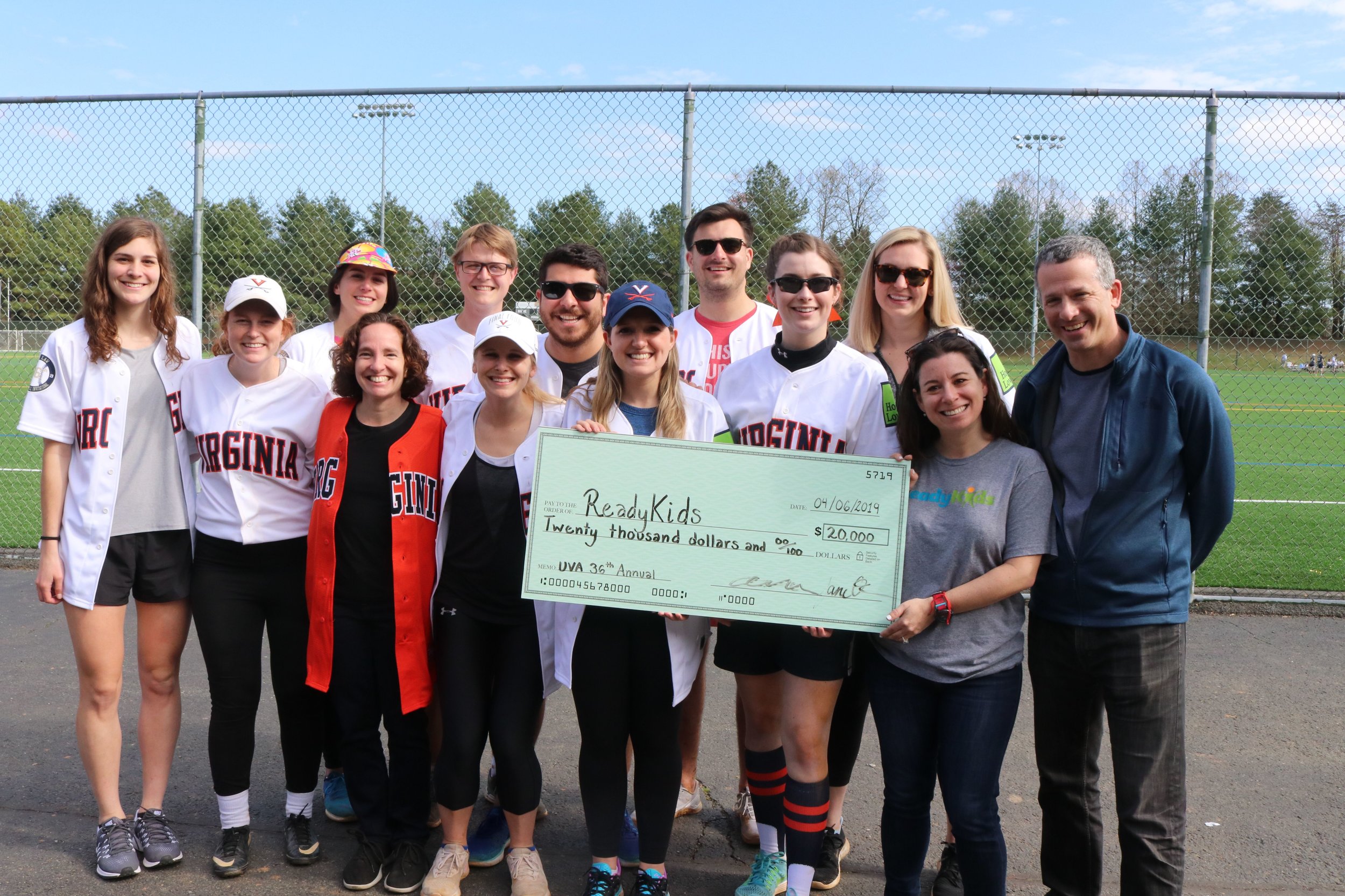 A group of students from the North Grounds Softball League along with Dean Risa Goluboff and Professor Rick Schragger presented a donation check to ReadyKids from the proceeds of the 36th Annual Softball Invitational. Photo credit Mary Wood Schmalzl.