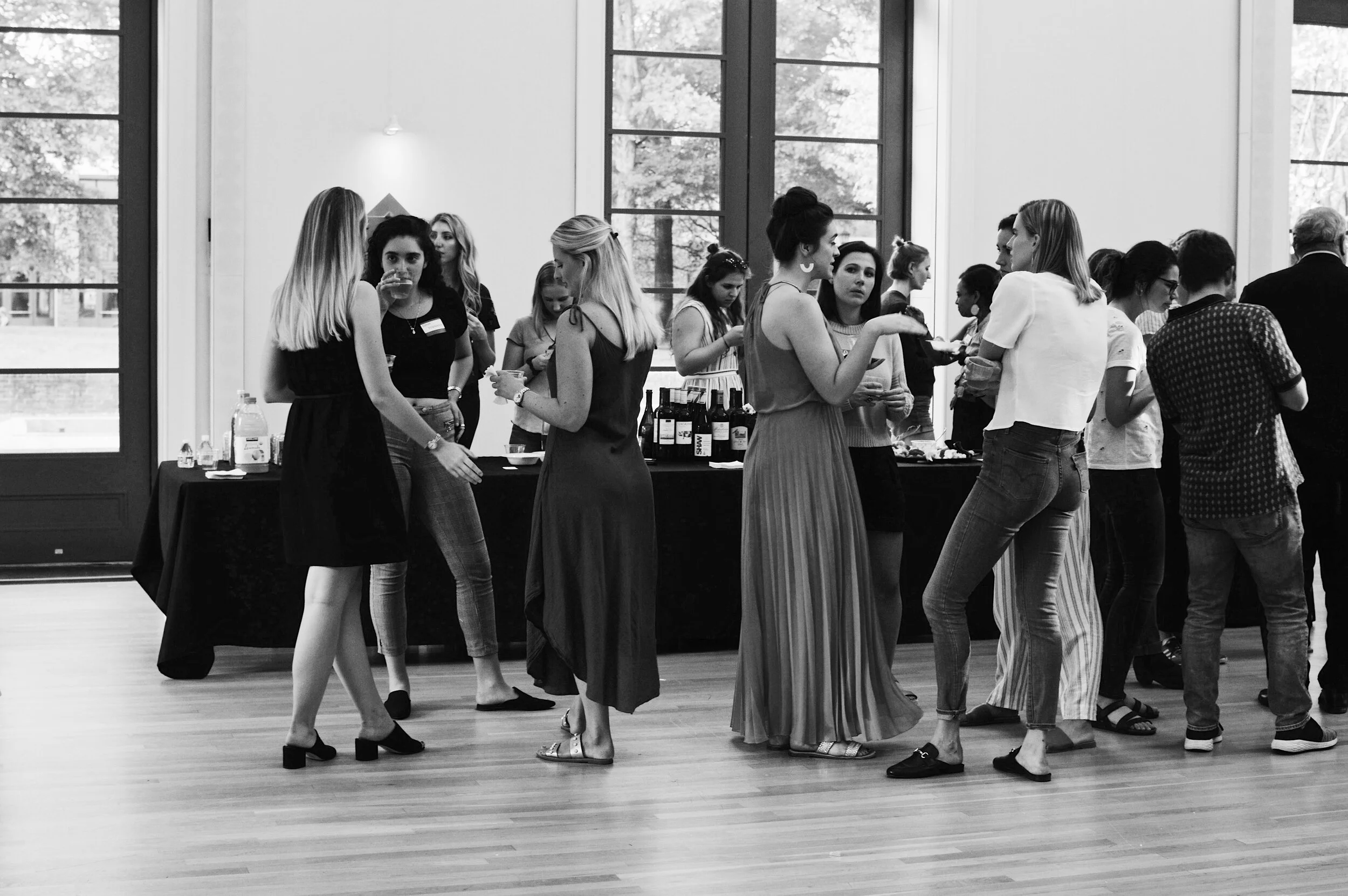 Students stand in classy circles at VL'W’s wine and cheese night. Photo Credit Kolleen Gladden ‘21.