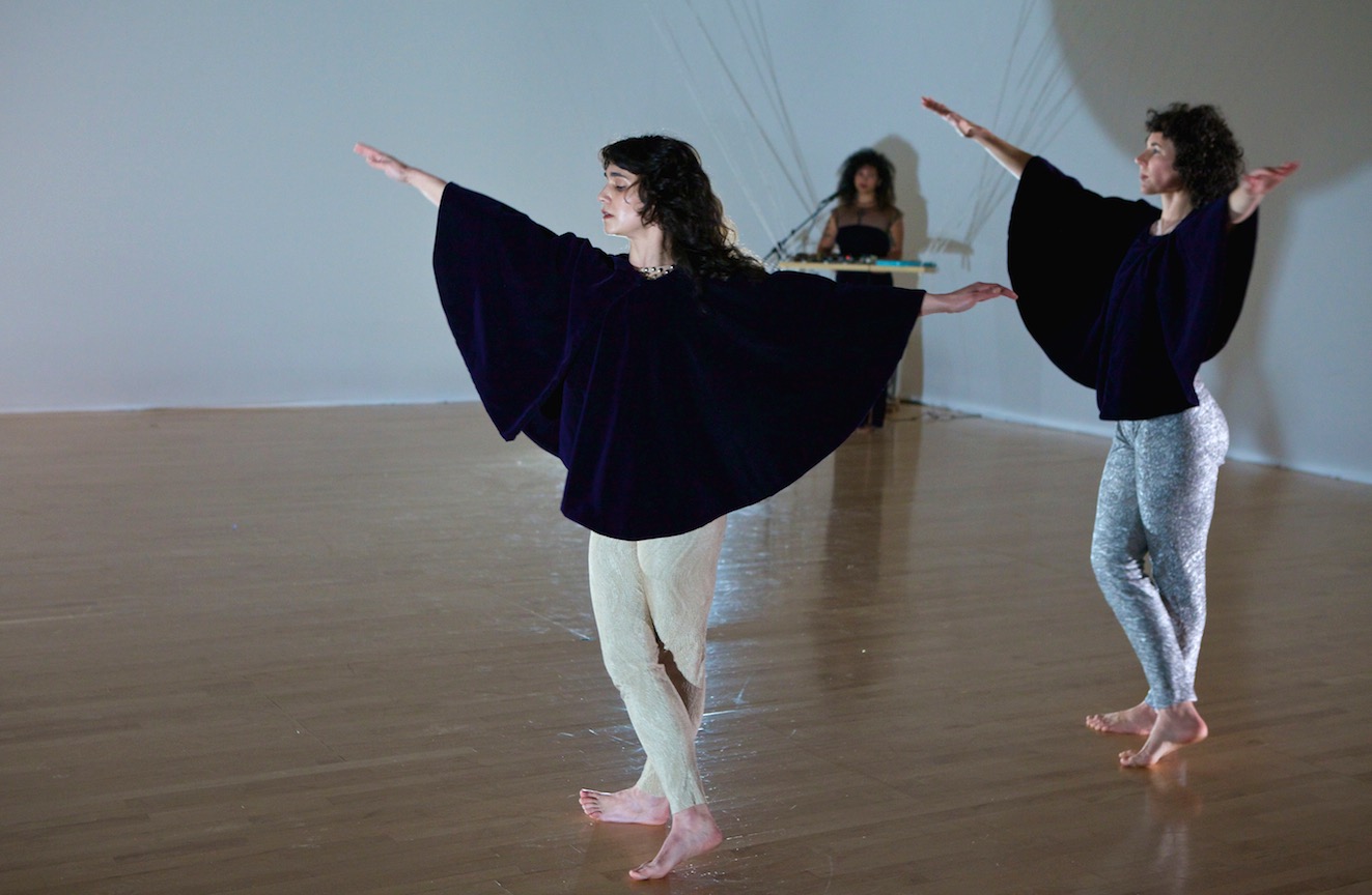 "Dancer/Choreographer Suniti Dernovek's latest production, "A Leading Light", is a collaboration combining the movements of Allie Hankins, Dernovsek herself, and sound artist Holland Andrews. It seems a purposeful deconstruction in terms of cast and set design, resulting in focused yet surrealistic storytelling. A sense of opposition and danger is always present, but ultimately so is the strength to face it. Even at points when the performers crash to the ground or rap their knuckles on the floor, it feels as much a reaffirmation of physical self and surroundings than a representation of harm or failure. Dernovesek is an artist who possesses the ability to translate idea into movement on a relatable and universal level while retaining an awareness of the audience and respect for their power of interpretation. Throughout this process her artistic fingerprint is always present."