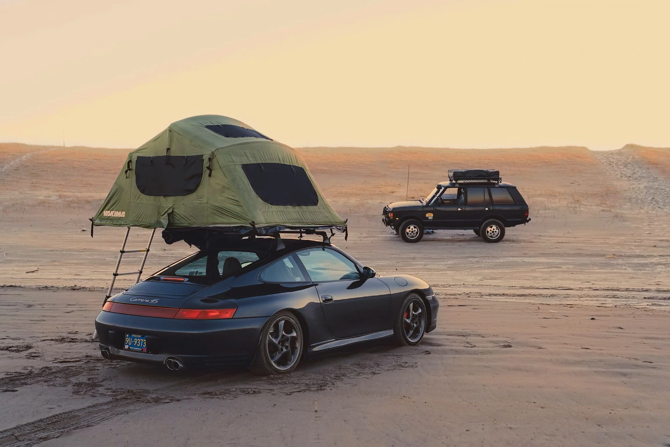 A Porsche With a Roof Top Tent 