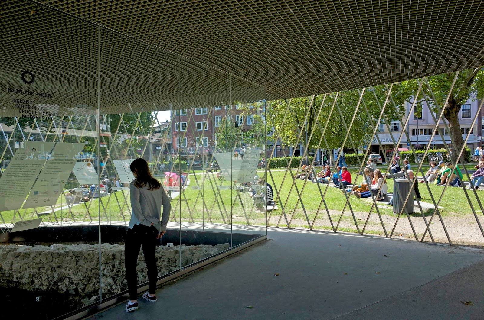 The ruins are encased with a glass wall and the stainless steel structure is open to the park.