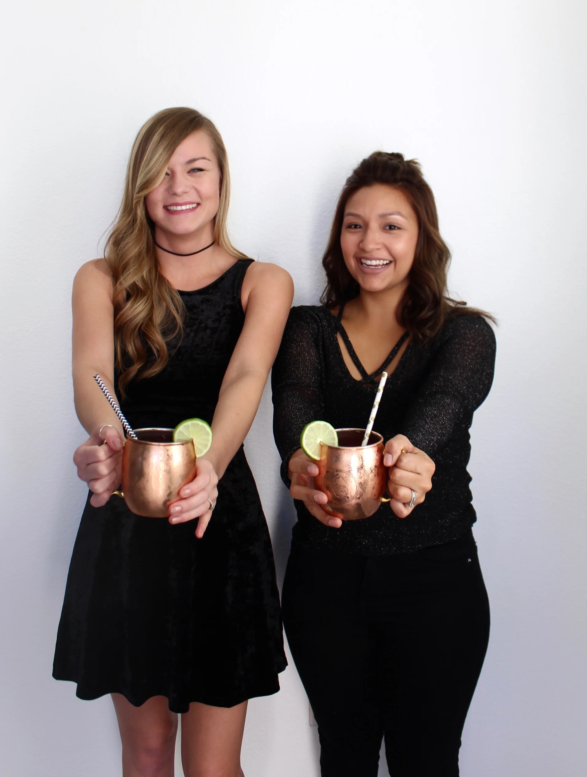 Holiday Party Fashion/ Cheers with Copper Mugs/ Cranberry Moscow Mules garnished with lime 