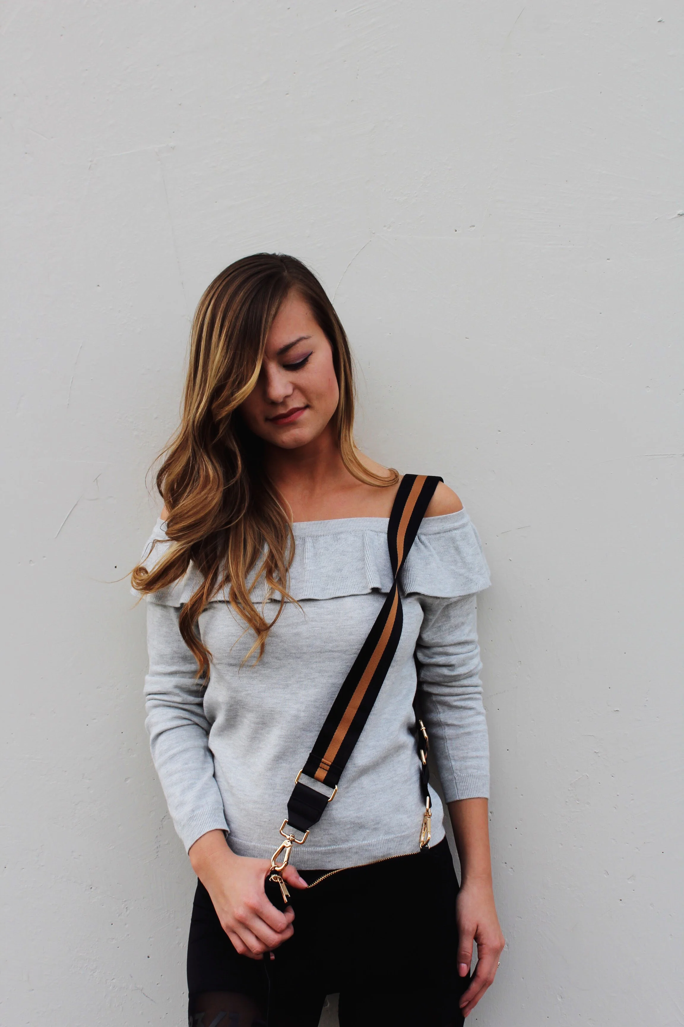 Grey off-the shoulder knit with ruffle details