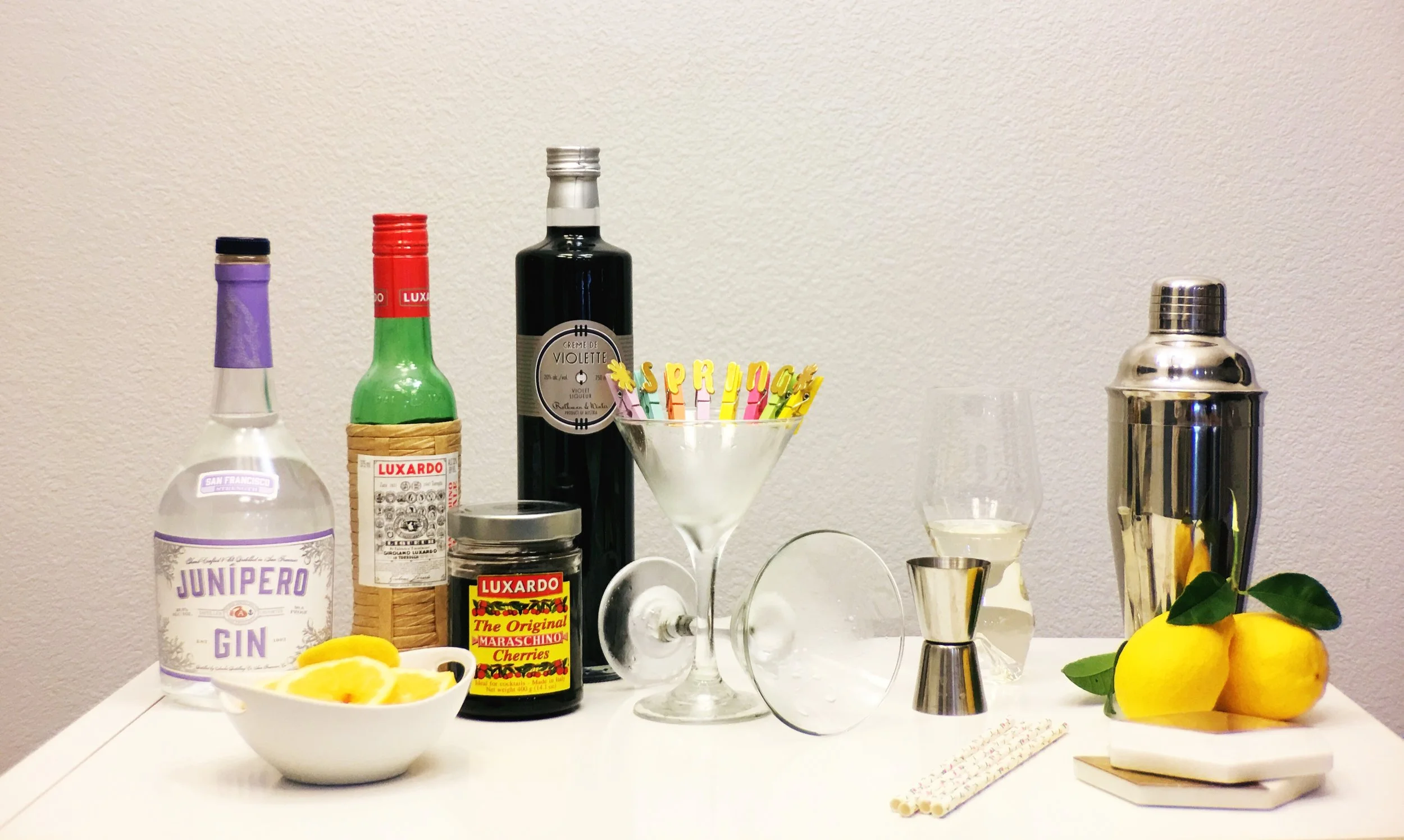 Ingredients for an Aviator Cocktail. Junipero Gin, Luxardo Marachino Liqeur, Creme De Violette and lemons 