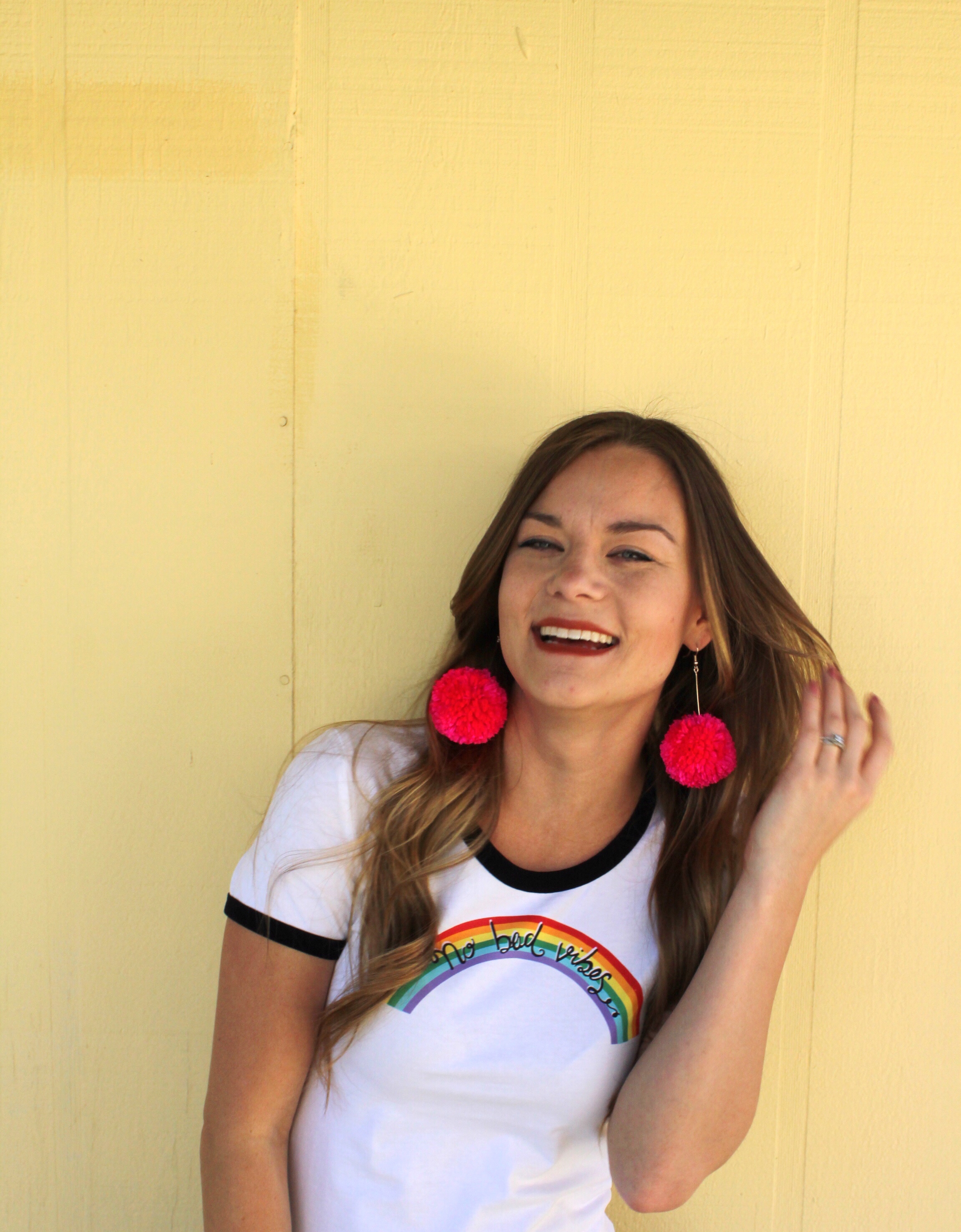 Hot Pink Pom Pom Earrings and No Bad Vibes Rainbow 70's Style Ringer Tee 