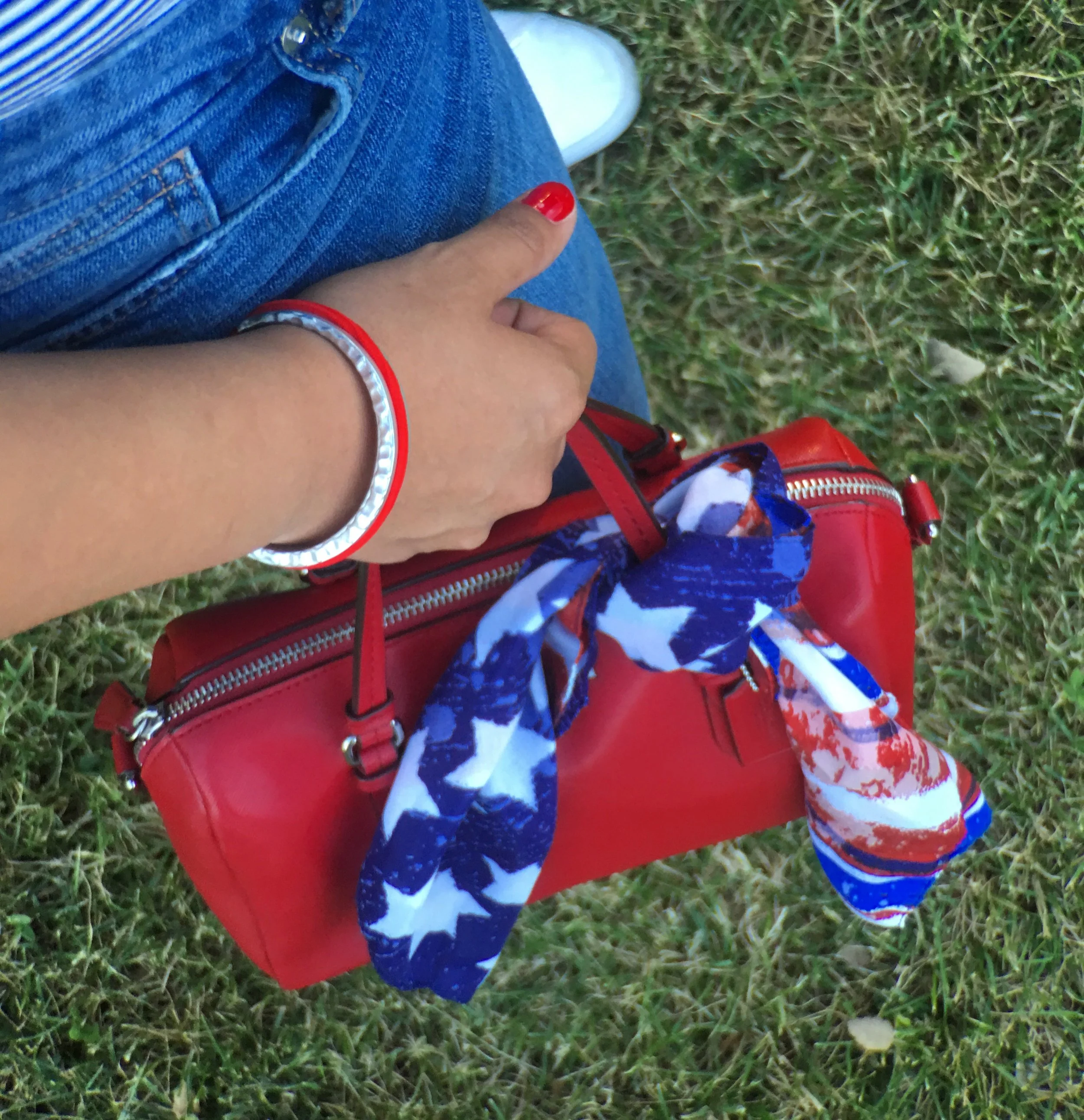 Red Coach Handbag with American Flag Scarf Detail and a Maria Shireen Silver Artisan HairTie Bracelet. 
