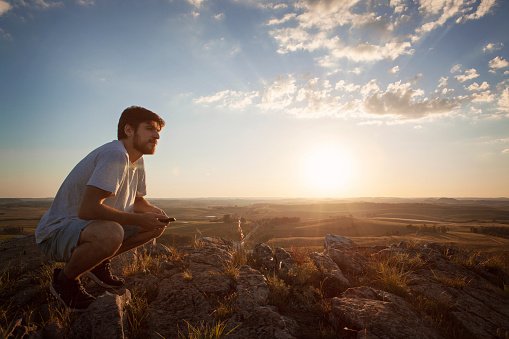  Beautiful young man looking away with sunlight. 