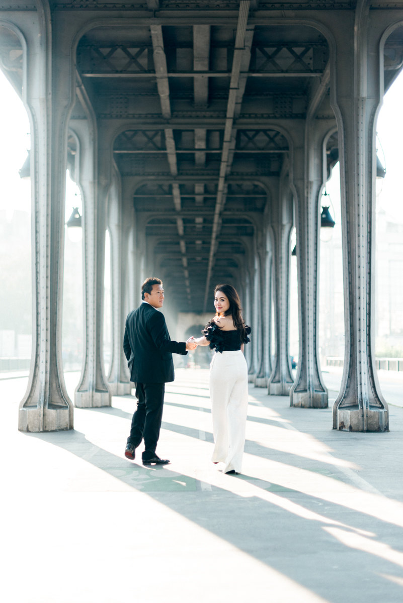 Photographer in paris - Walking together under a bridge in Paris during a couple photo shoot