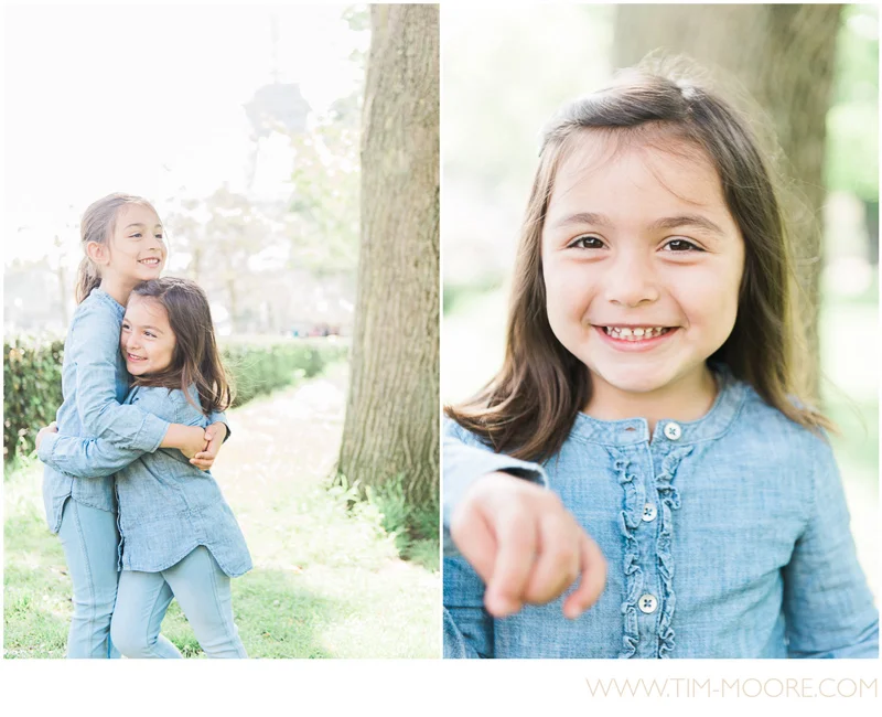 Girls hugging and smiling during their Paris family photo shoot with Tim Moore
