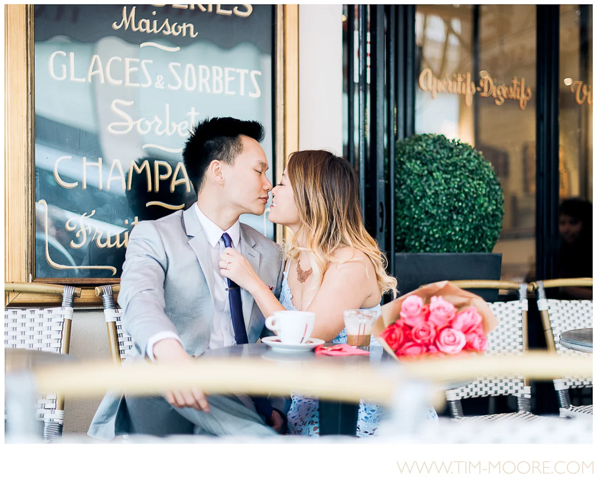Paris photographer Tim Moore - Juli and Anh-Tuan deeply in love and having a fantastic time in this Café during their intimate Paris photo session