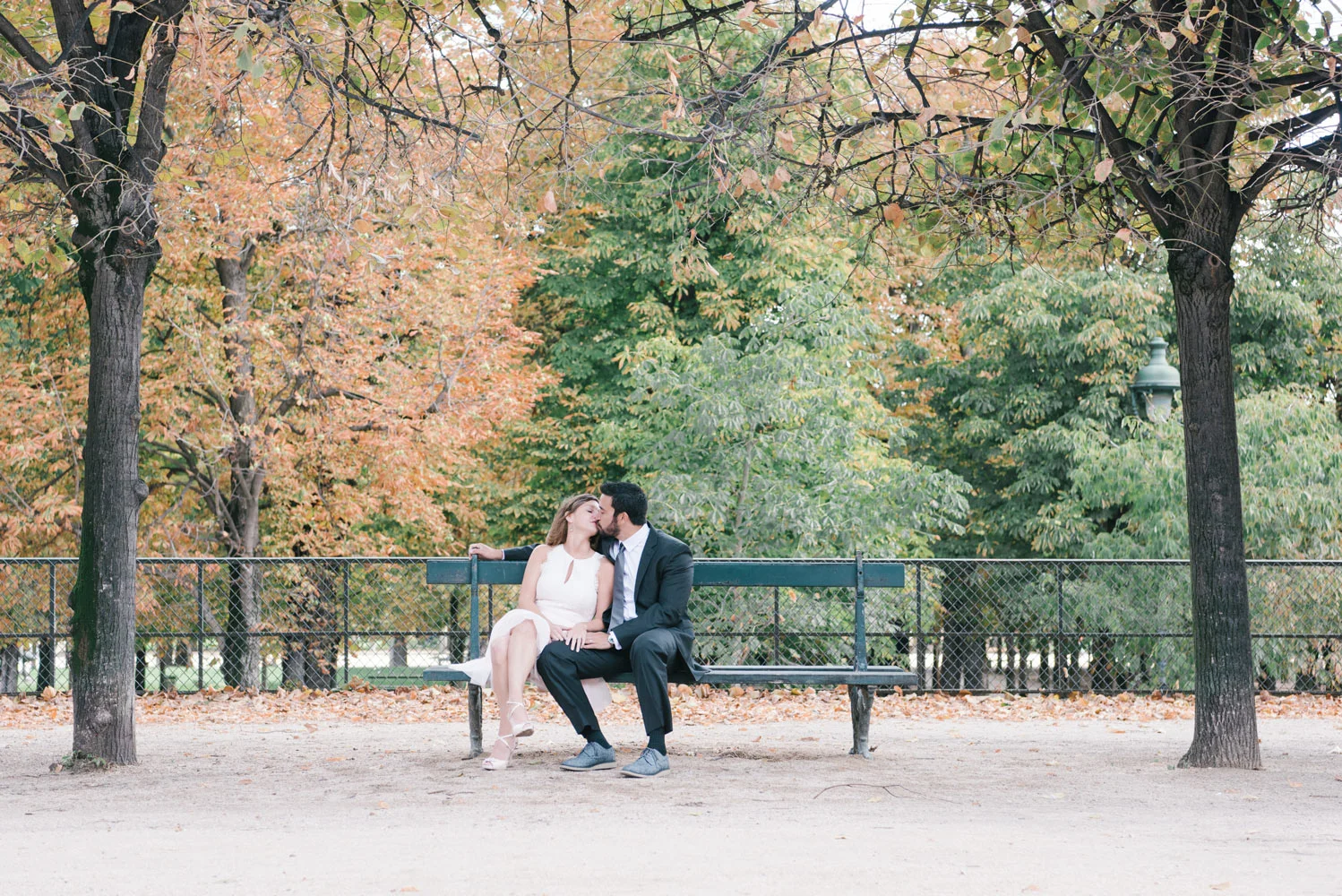 Paris Photographer Tim Moore captures the love of this couple kissing on a bench at the Tuileries Gardens in Paris.