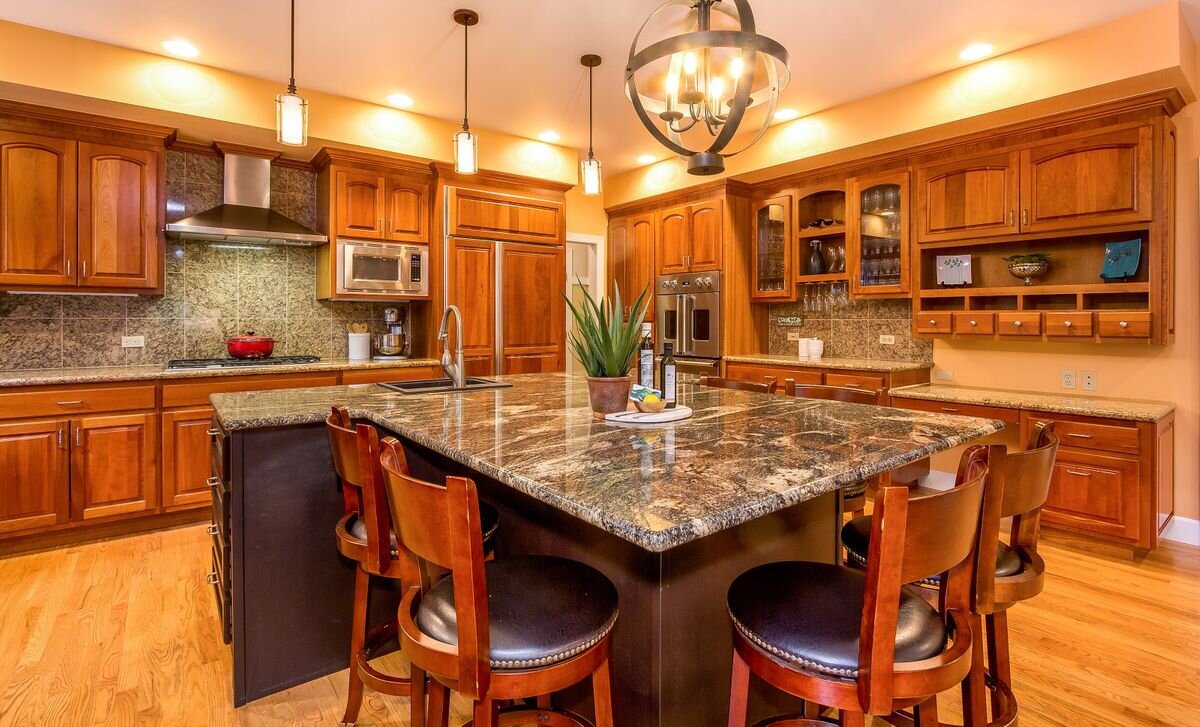  This kitchen is definitely the heart of the home, with an exquisite granite island that seats six! It offers beautiful cherry cabinetry with beverage and home organization areas. The high-quality appliances are a cherry-paneled Sub-Zero fridge, newe