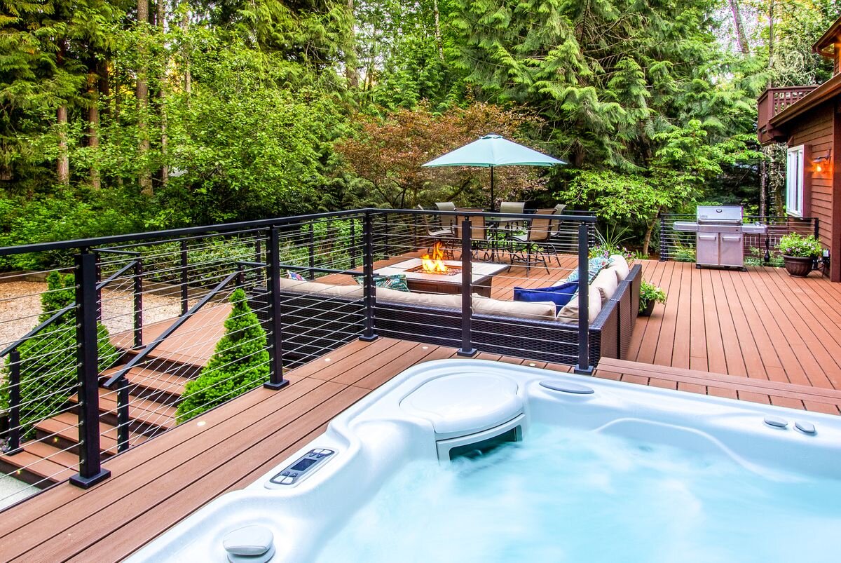  The newer salt water hot tub is set into a raised section of the deck for a spa-like experience in your own backyard. Low voltage lighting beautifully illuminates the edges of the deck and steps. 