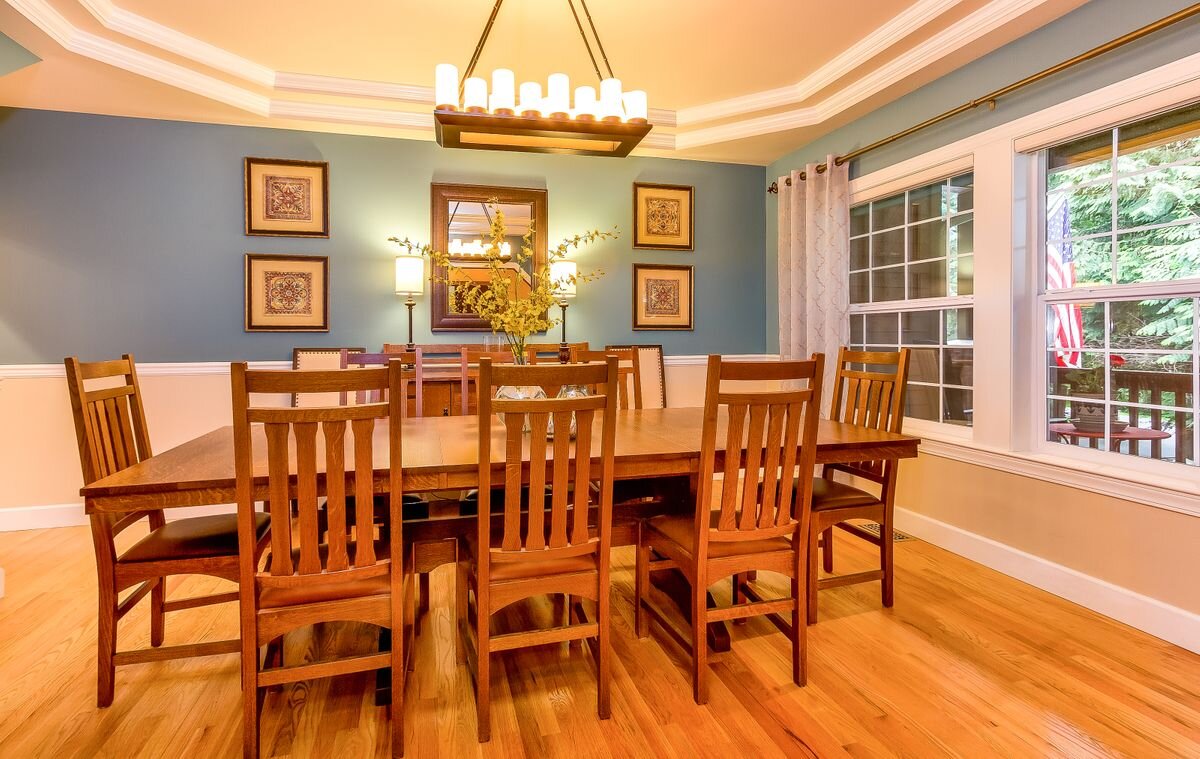  The elegant formal dining room has plenty of space for a large table and hutch. It features a coved ceiling and hardwood floors. 